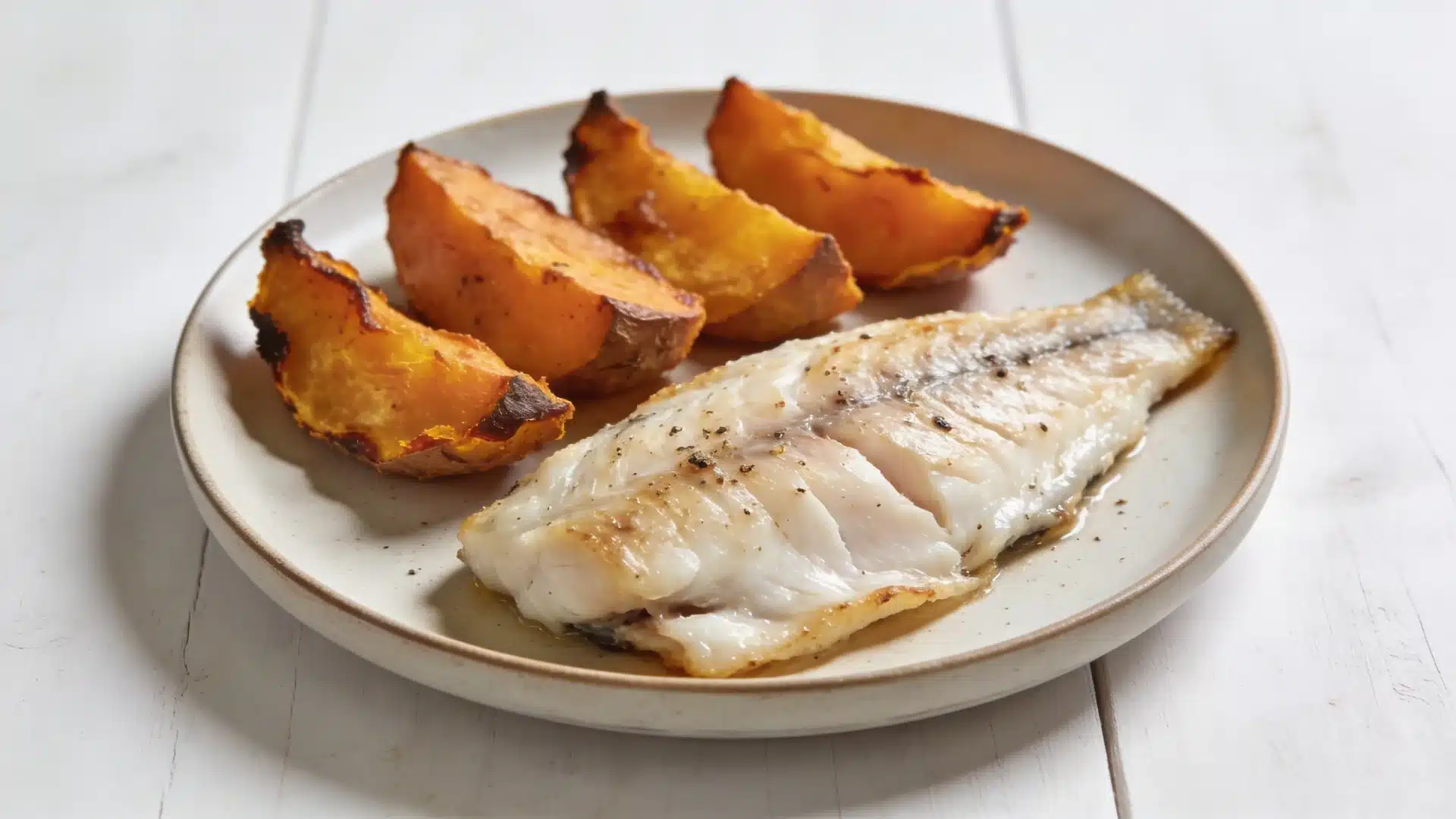 baked fish with sweet potato on a plate perfect for high protein snacks weight loss and healthy meals