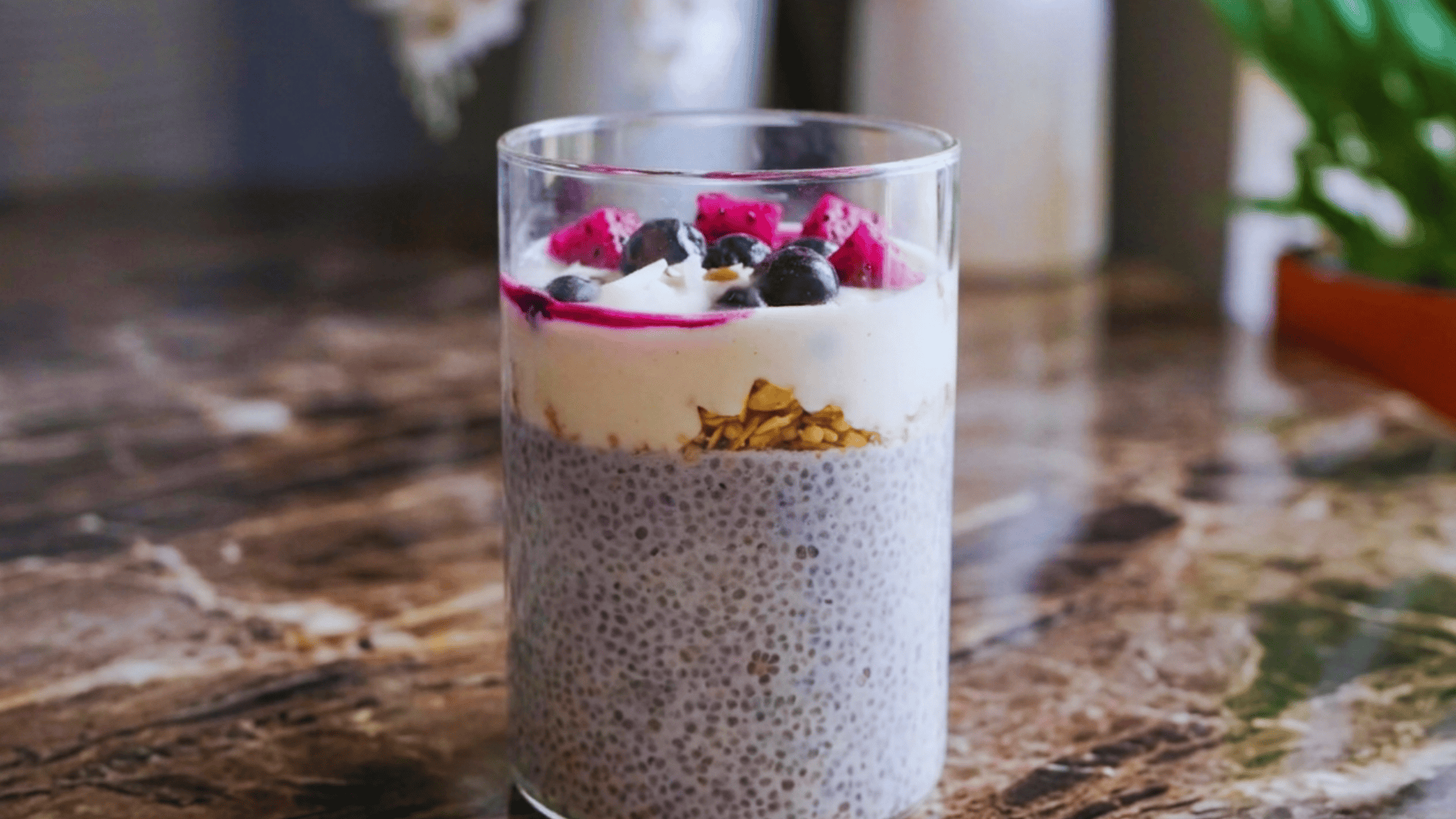 chia pudding with yogurt granola and berries in a glass