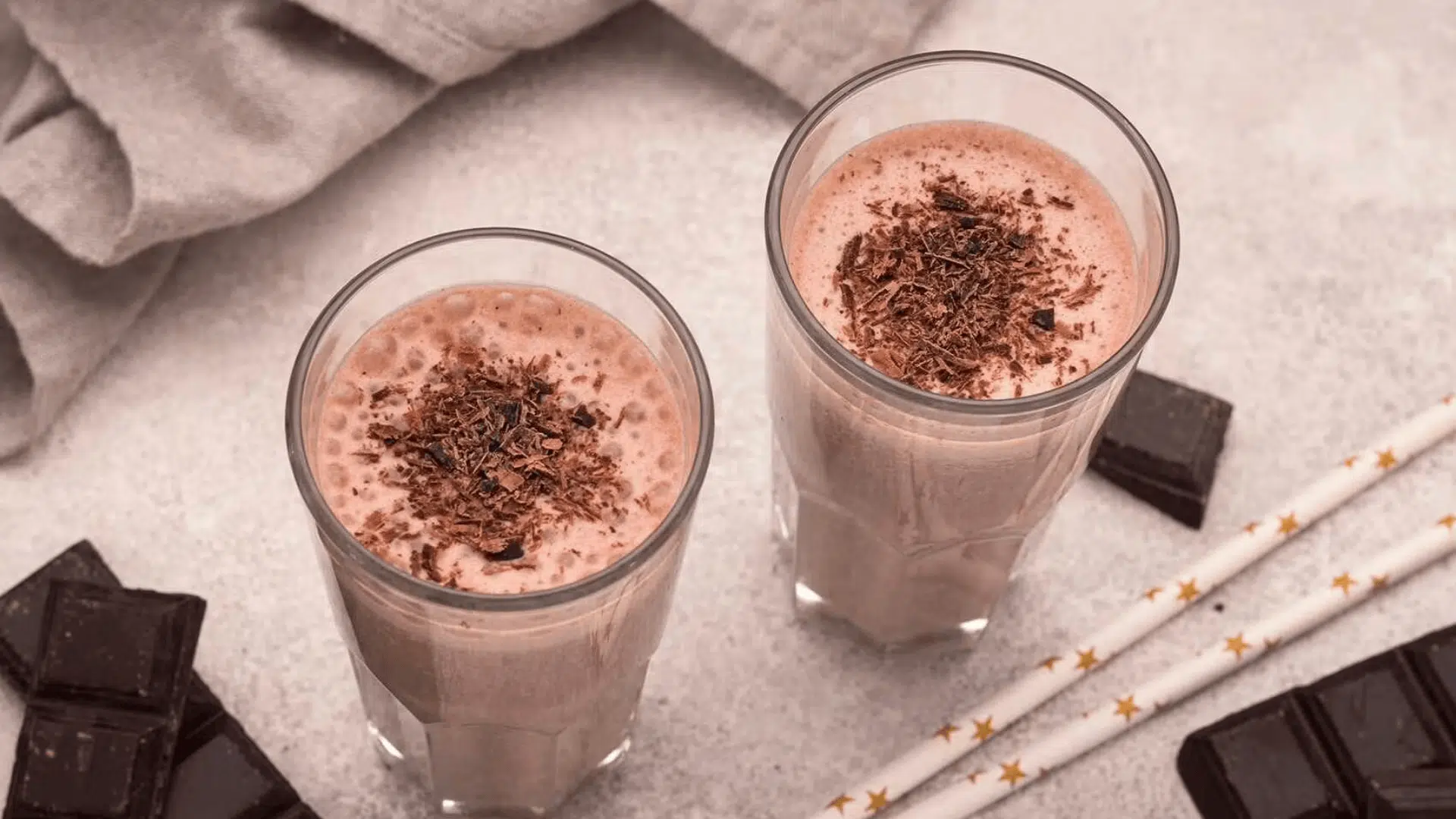 chocolate smoothie topped with grated chocolate beside chocolate pieces and straws what is the best recovery food