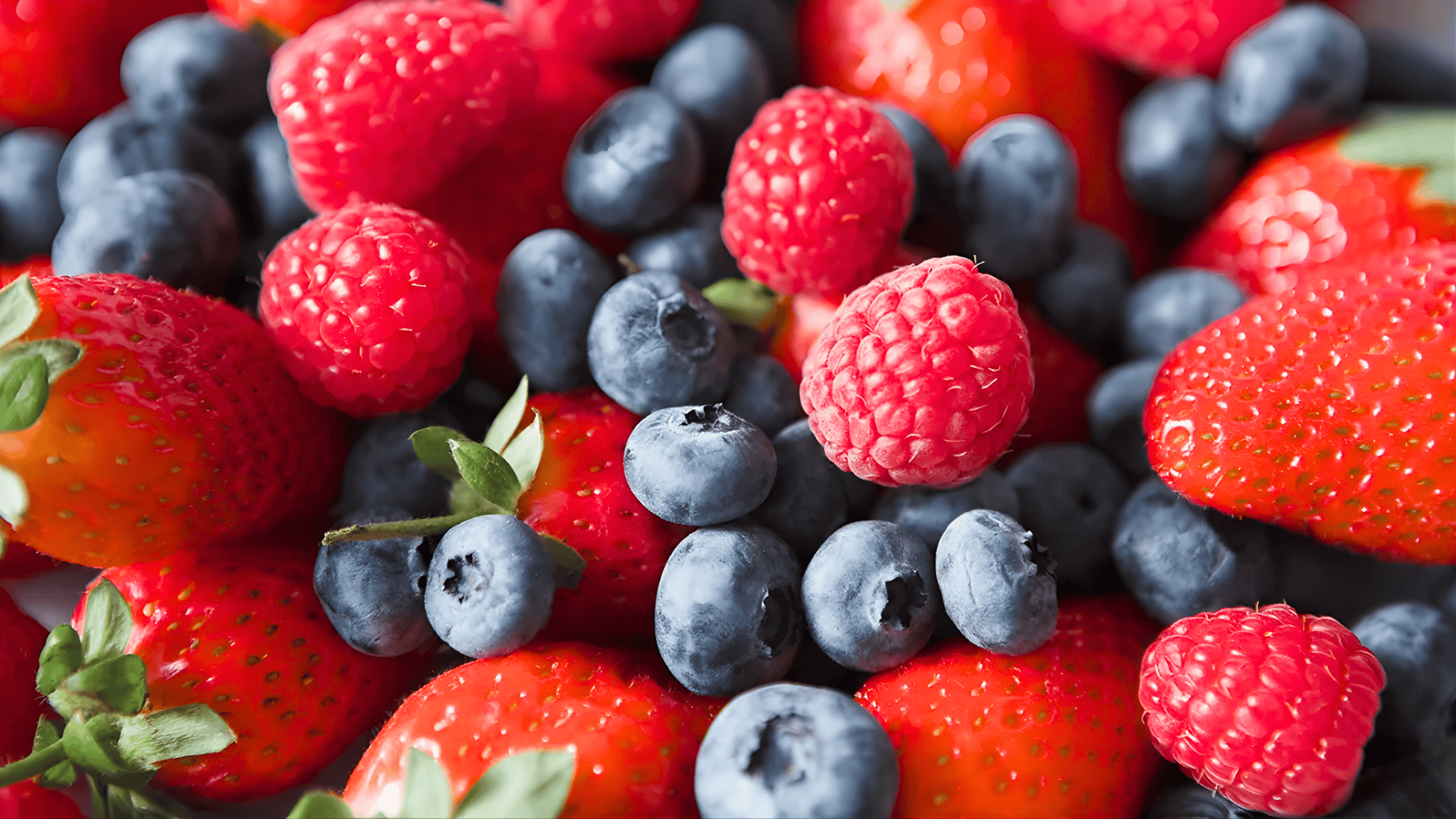 close up of fresh strawberries blueberries and raspberries mixed together what is the best recovery food
