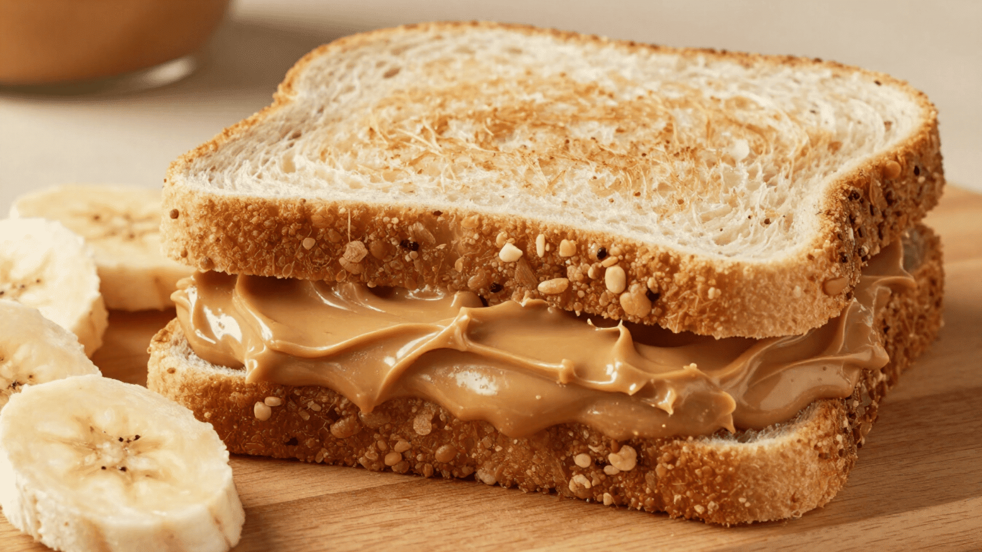 peanut butter sandwich with banana slices on board as quick post workout meal