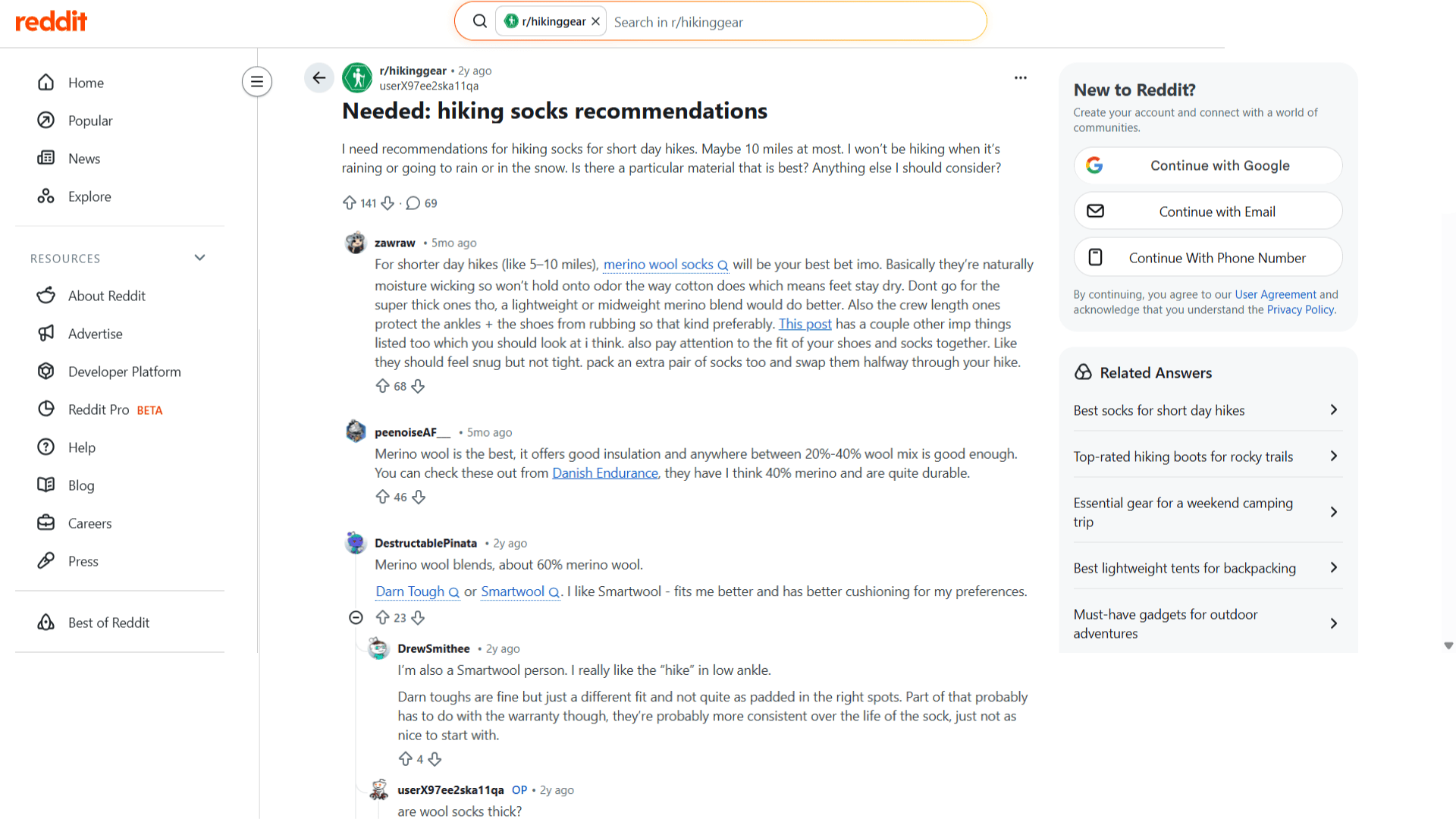 reddit page showing a post asking for hiking socks recommendations with user comments discussing merino wool and sock brands