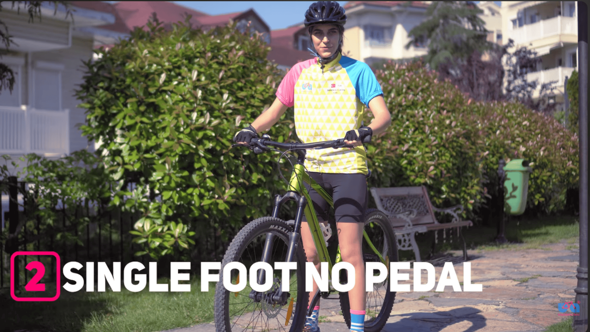 riding bike using one foot on pedal and one on ground to improve balance and control