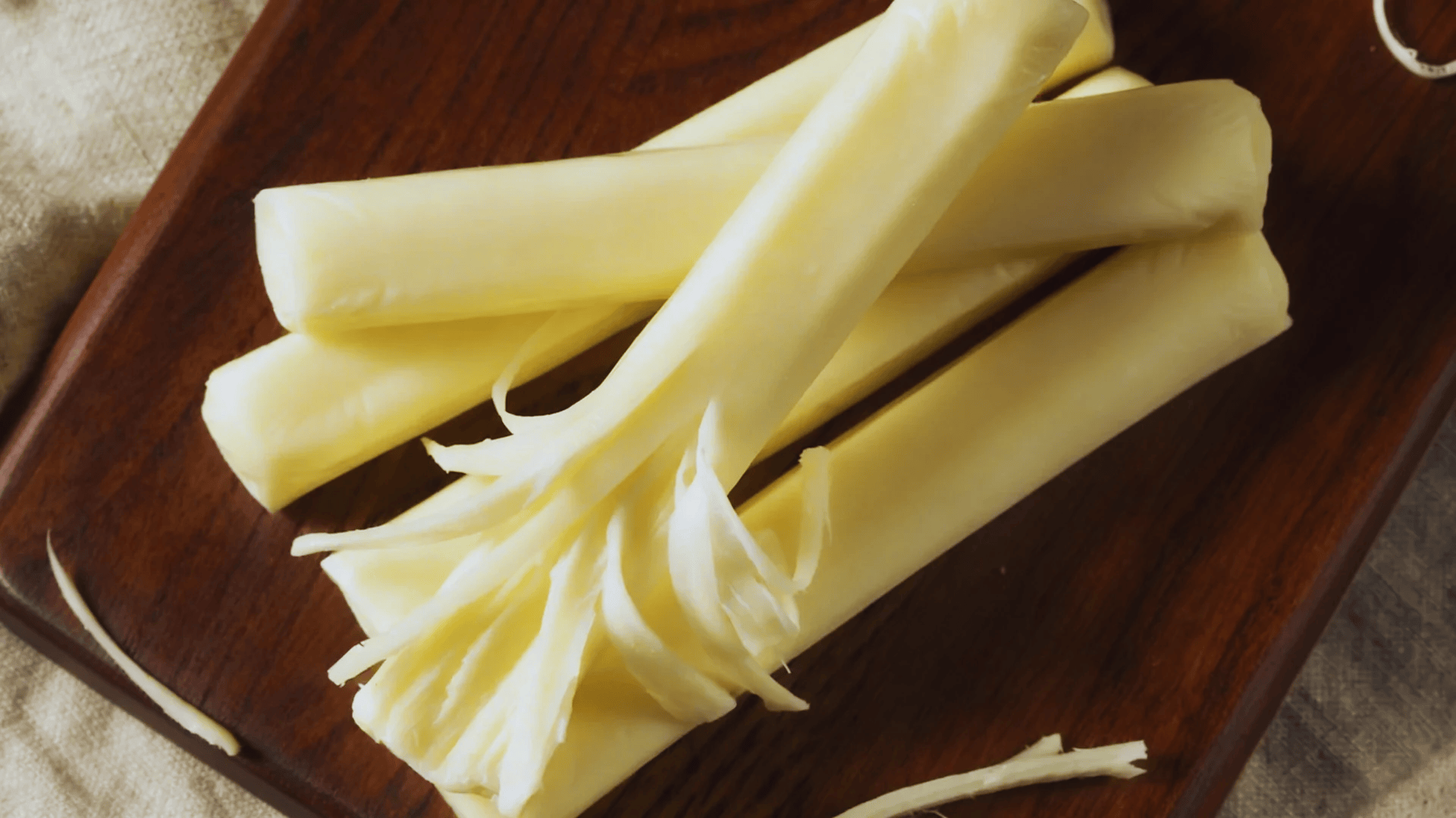 string cheese sticks on a wooden plate