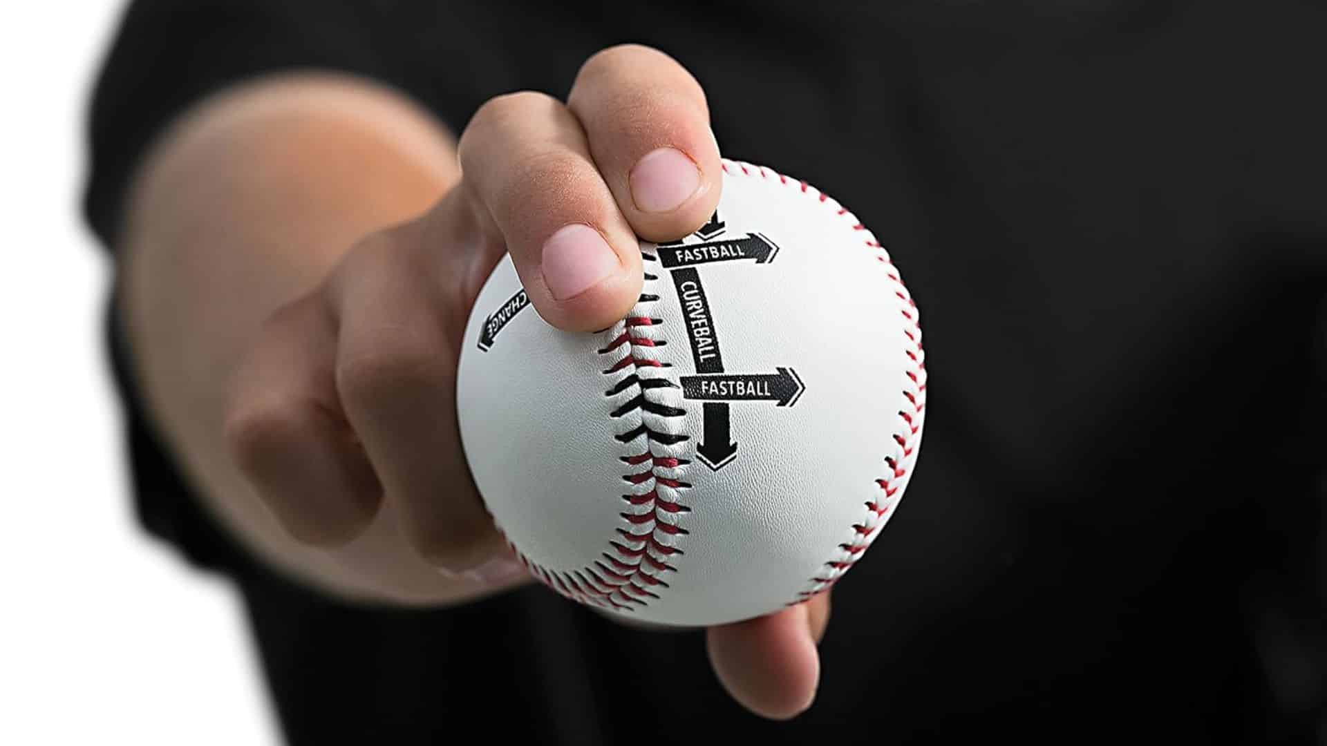 a close up of a hand holding a baseball showing labeled grip positions for different pitches against a dark background