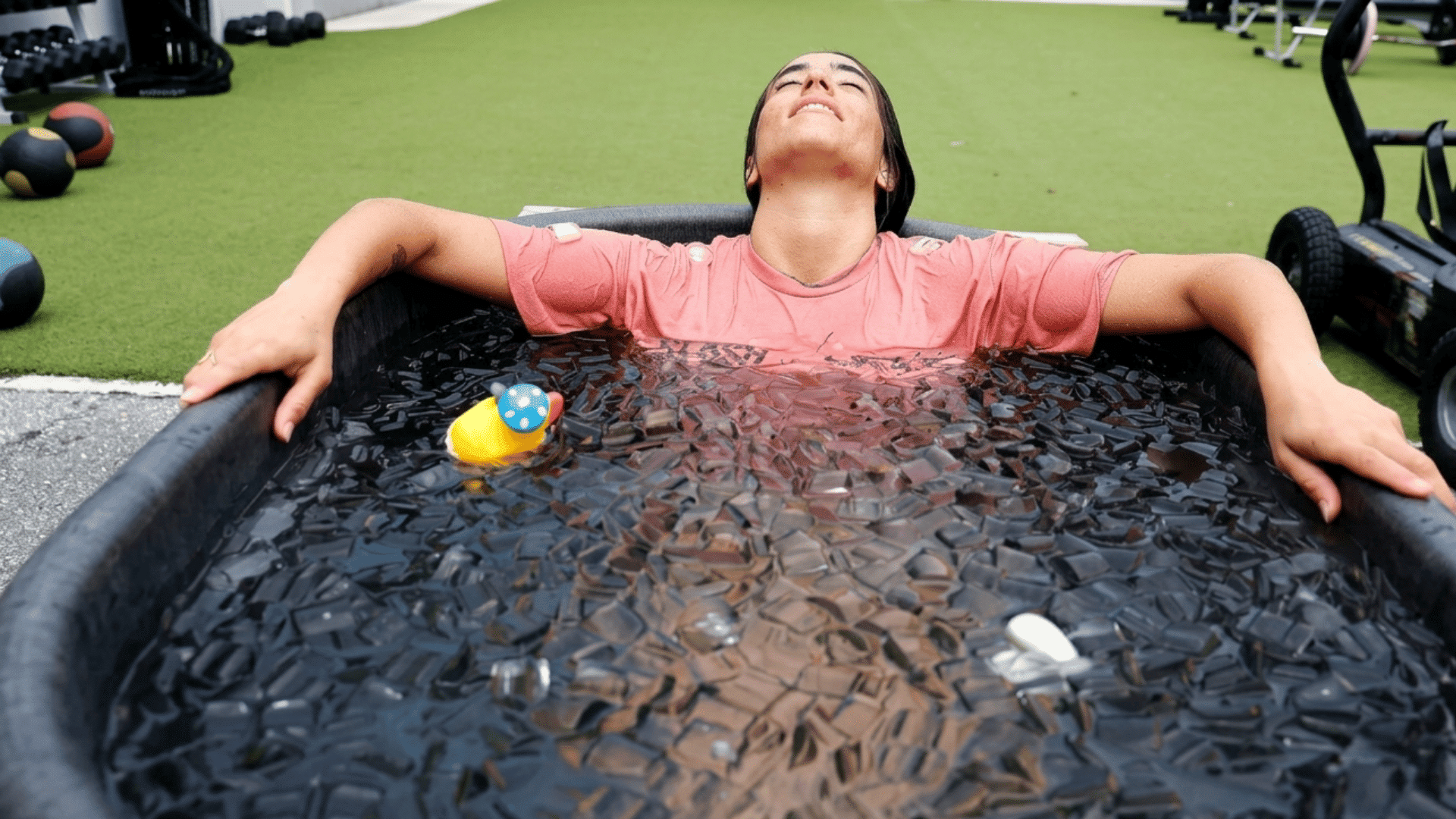athlete relaxing in an ice bath after training to support muscle recovery and reduce soreness