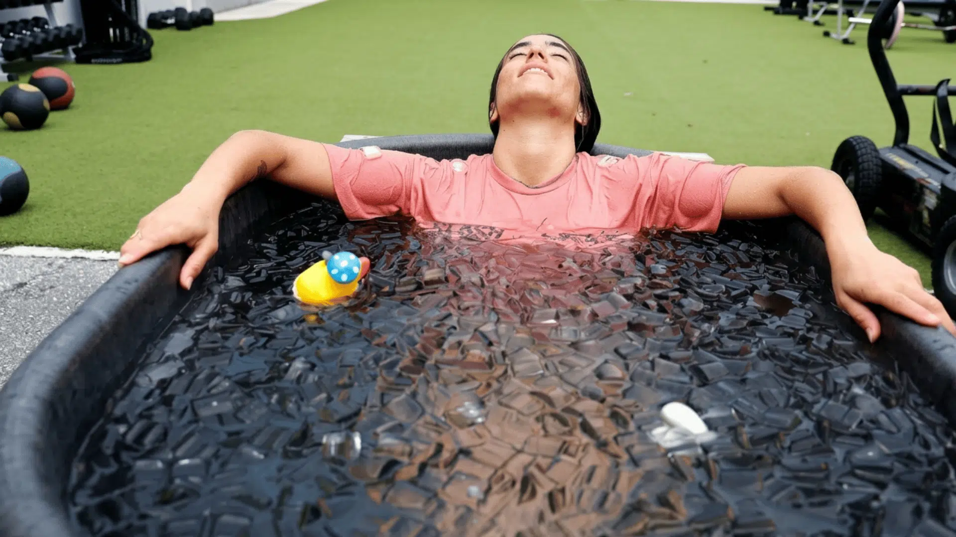 athlete relaxing in an ice bath after training to support muscle recovery and reduce soreness