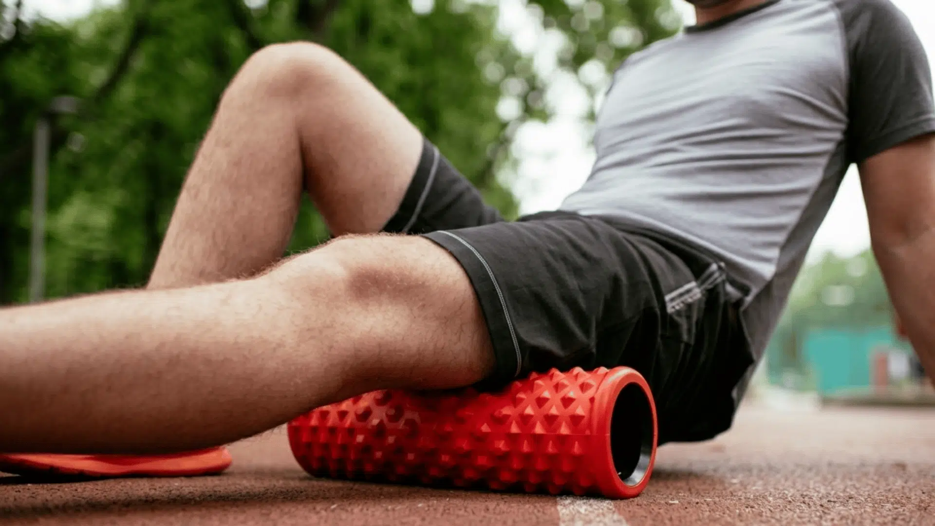 athlete using a foam roller on leg muscles after exercise to reduce soreness and improve recovery