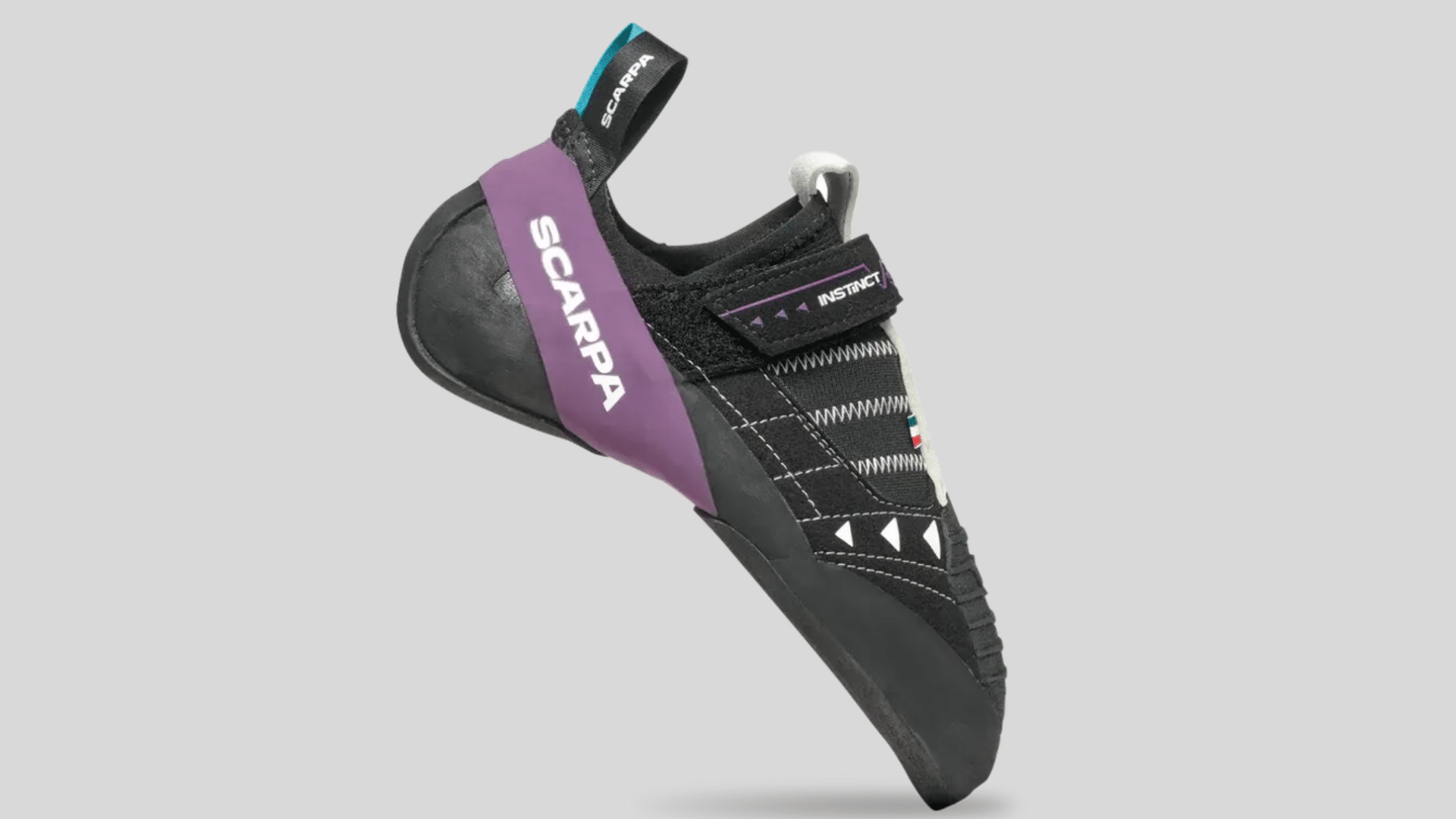 black and purple climbing shoe with strap closure and rubber sole designed for grip and precise footwork on a clean background
