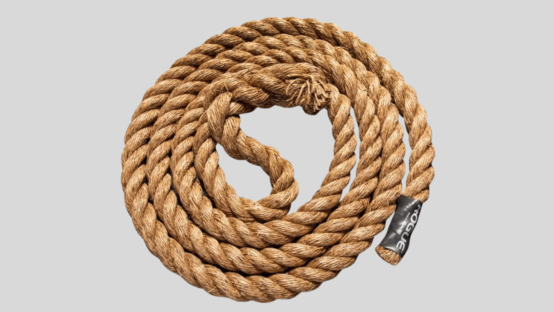 coiled brown rope made of thick twisted fibers for training or fitness use on a clean background