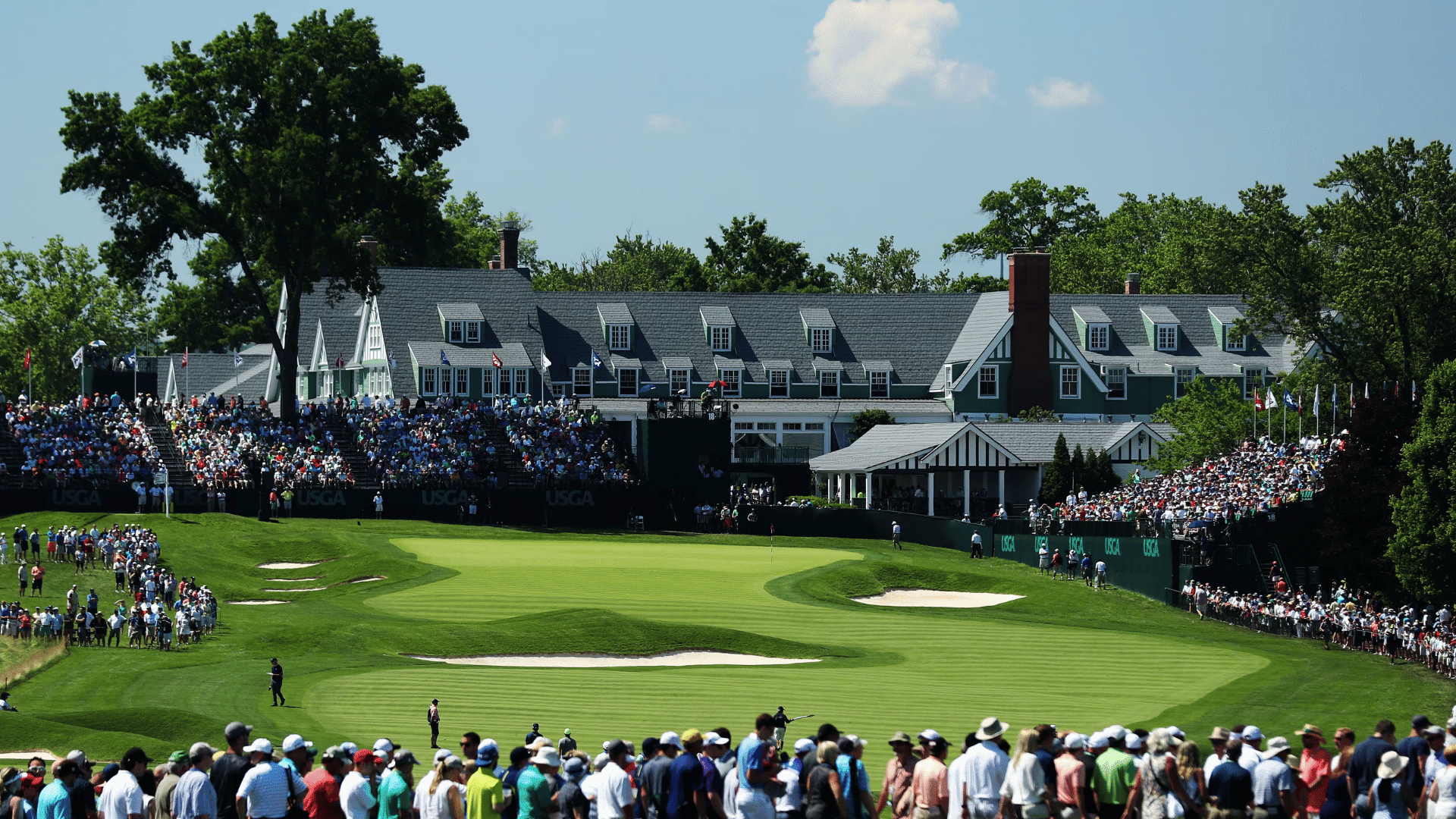 crowds gathered around the golf course during the us open championship on a bright sunny afternoon