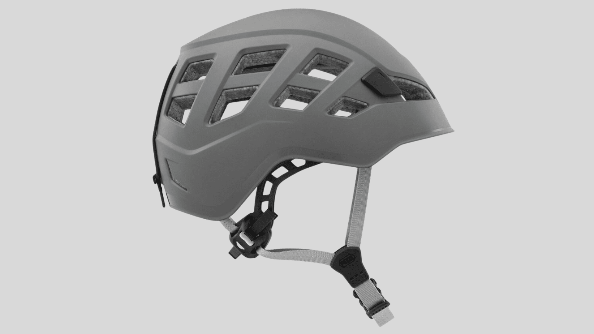 gray climbing helmet with multiple vents and adjustable chin strap designed for safety on a clean background