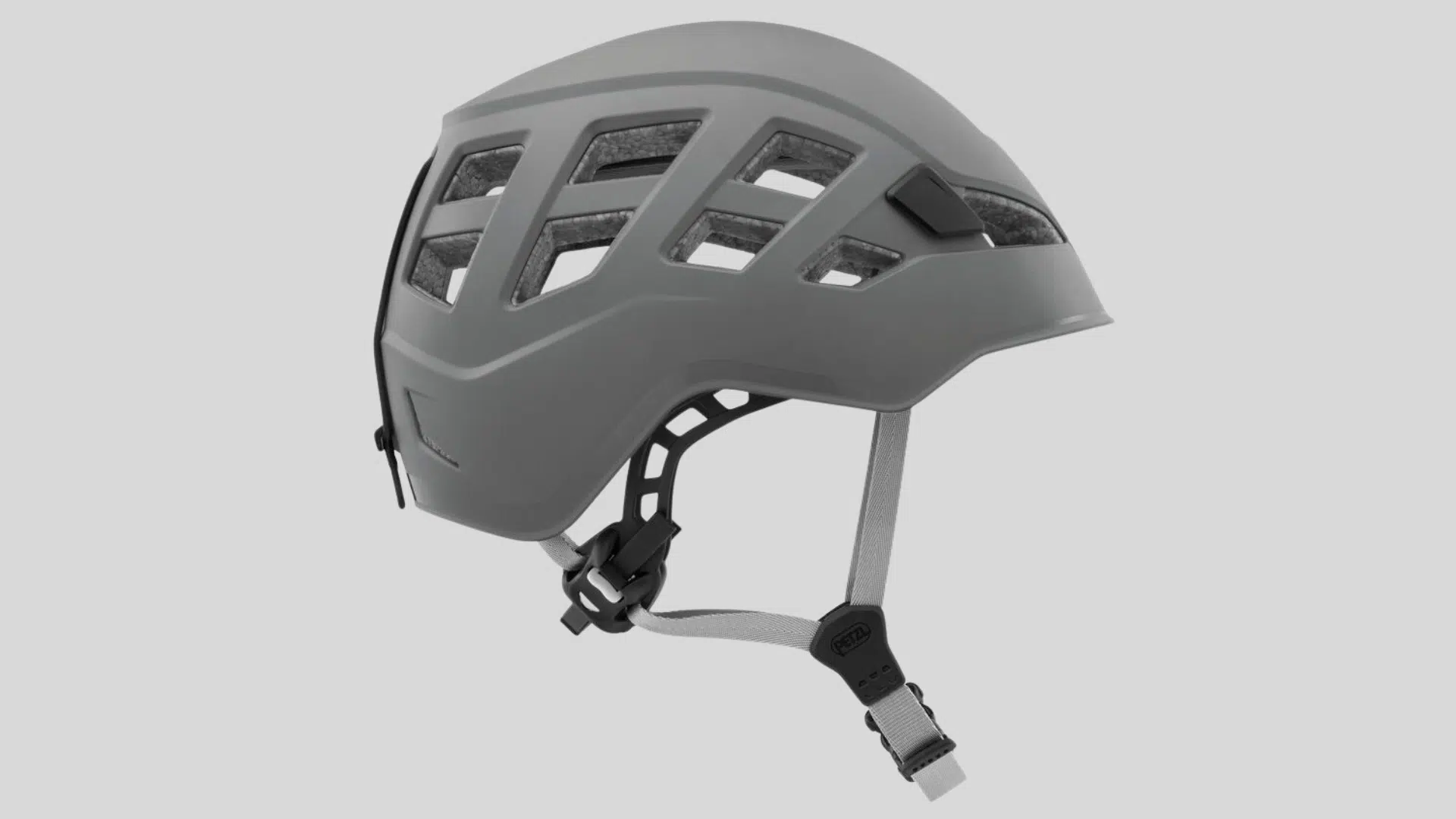 gray climbing helmet with multiple vents and adjustable chin strap designed for safety on a clean background