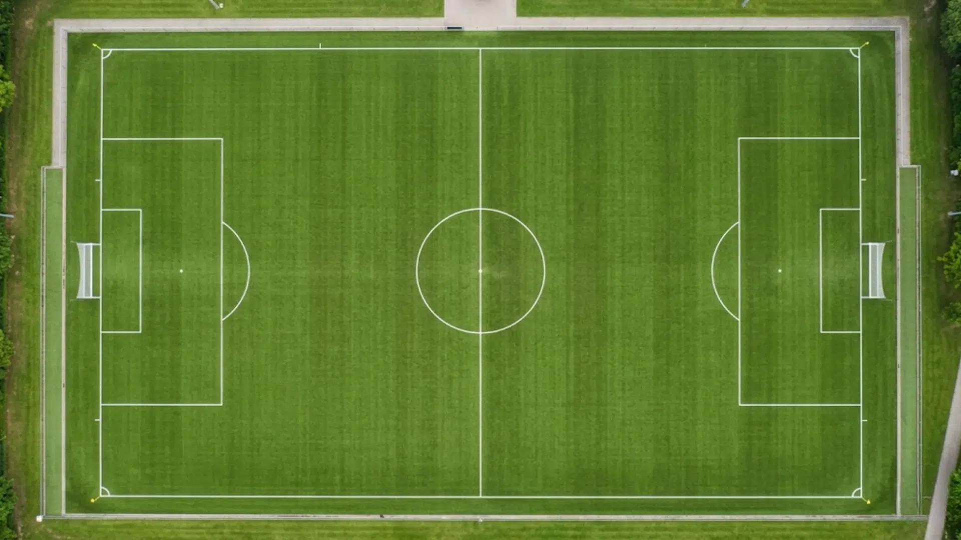 how many quarters in soccer shown on a marked green soccer field with goals and center circle