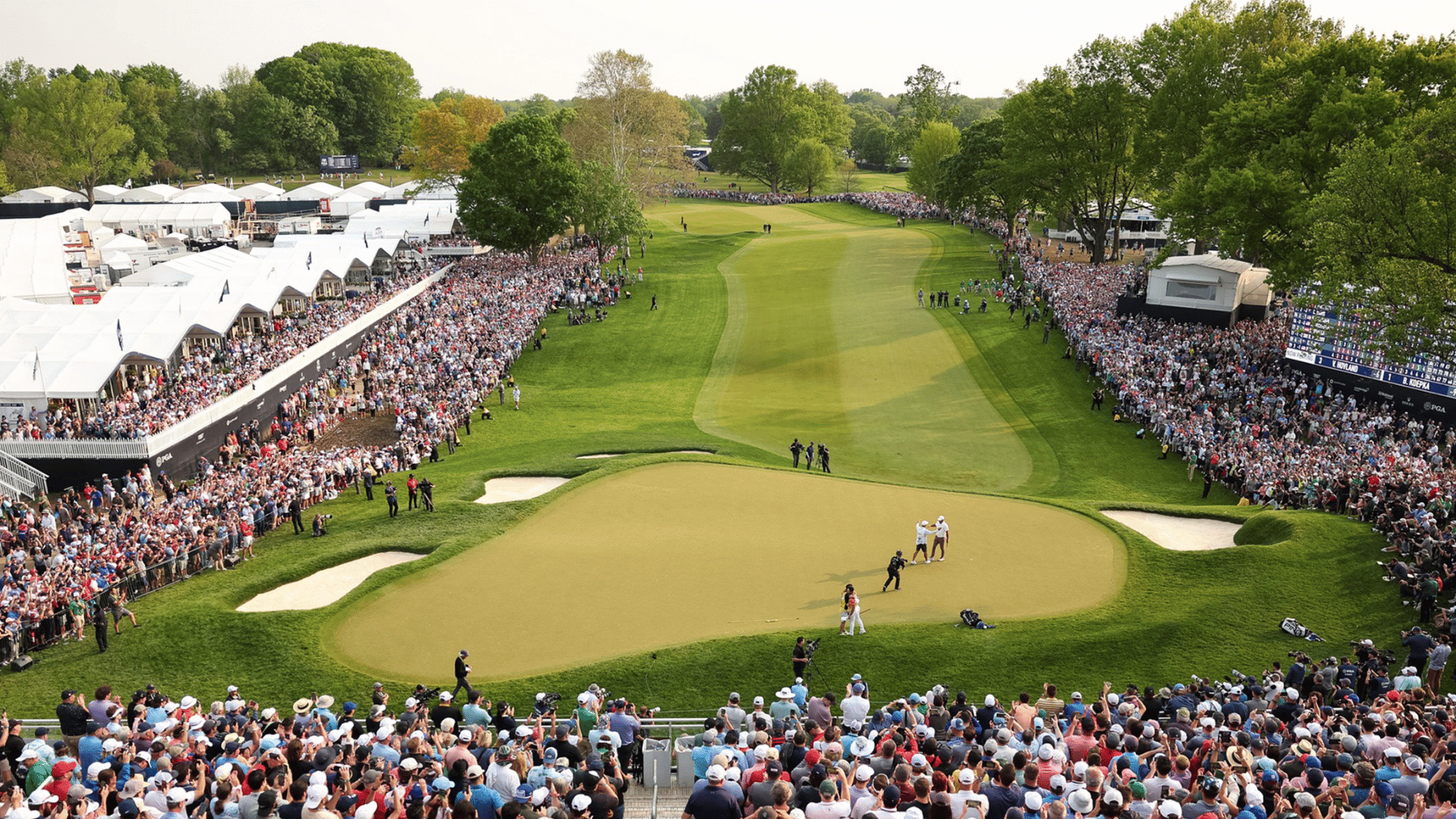 large crowds watching golfers during the pga championship on a packed course surrounded by green fairways