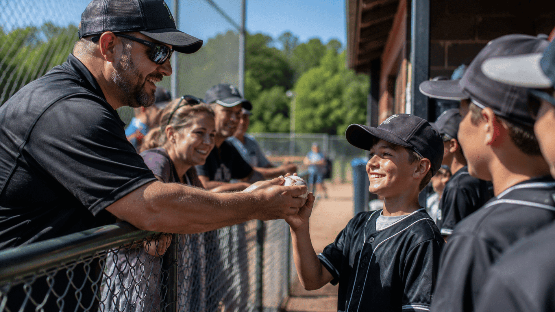 local supporter sponsoring young baseball player during community fundraiser at outdoor baseball field event
