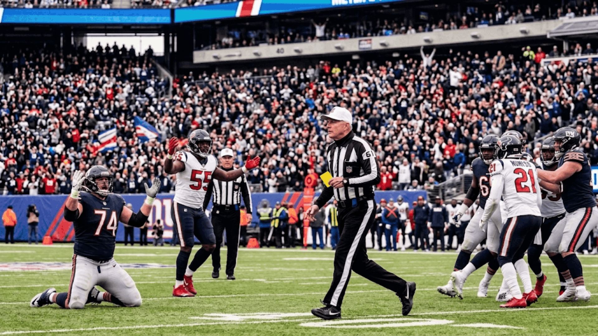 nfl referee throwing a penalty flag during a football game with players reacting on the field