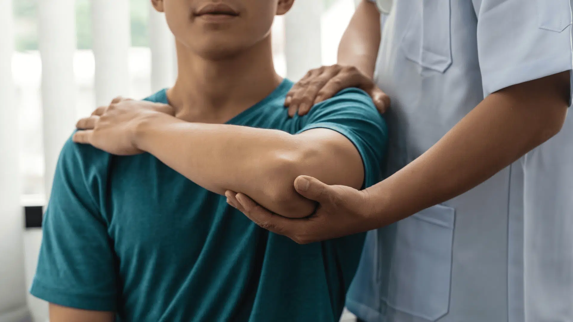 patient receiving elbow therapy during tommy john recovery time treatment with guidance from a medical professional