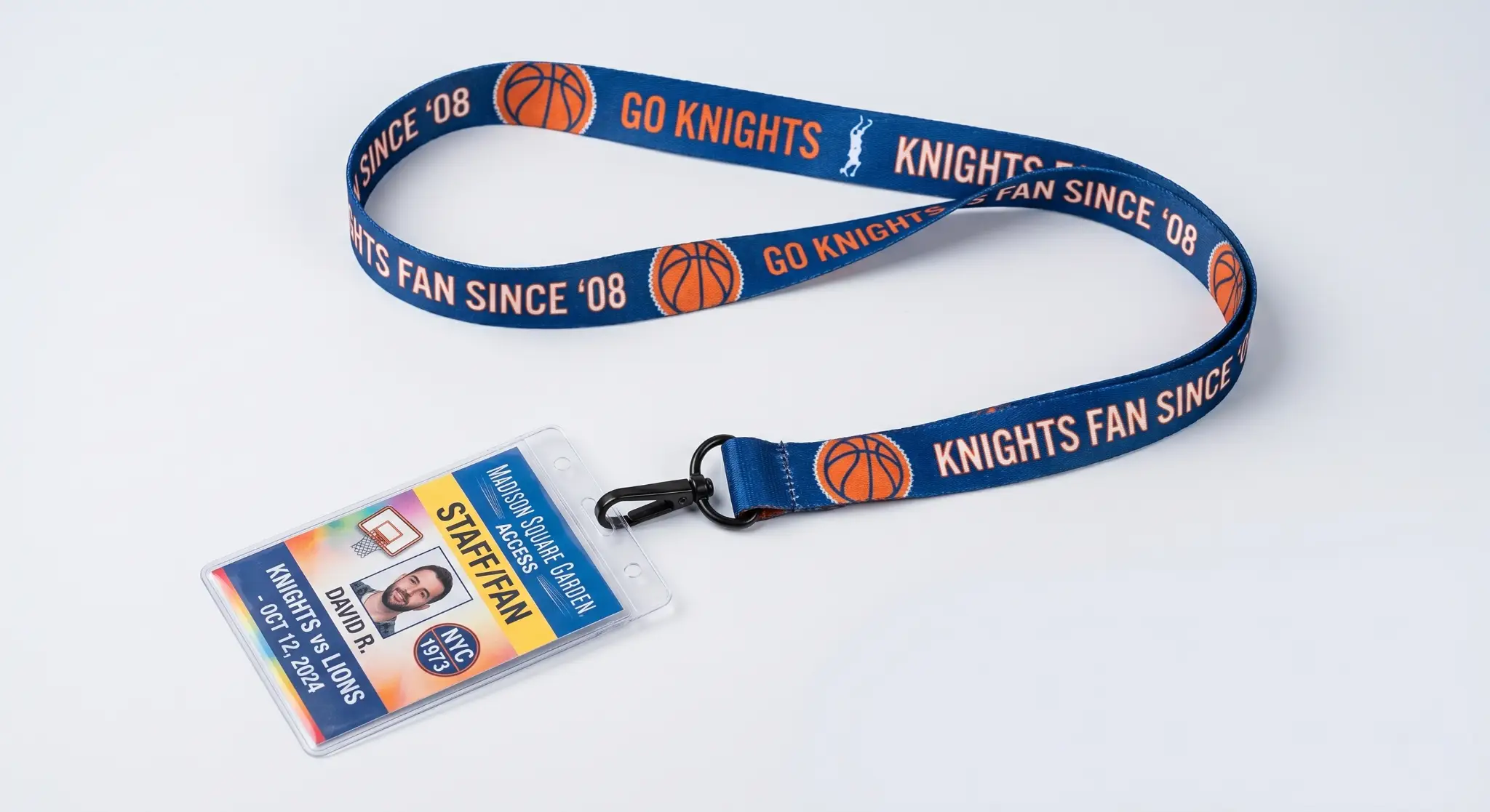 Blue lanyard with basketball graphics and staff ID badge on white background