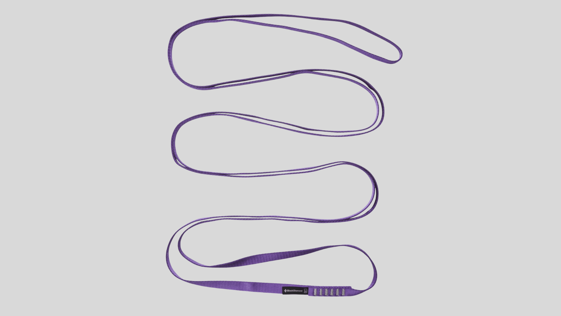 purple climbing sling loop made of durable webbing for anchoring and protection use on a clean background