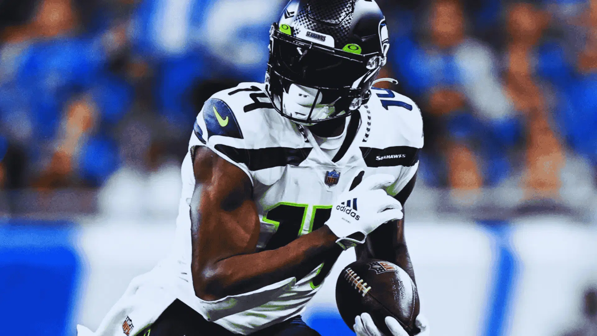 seahawks dk metcalf in number 14 runs forward holding football tightly during intense play