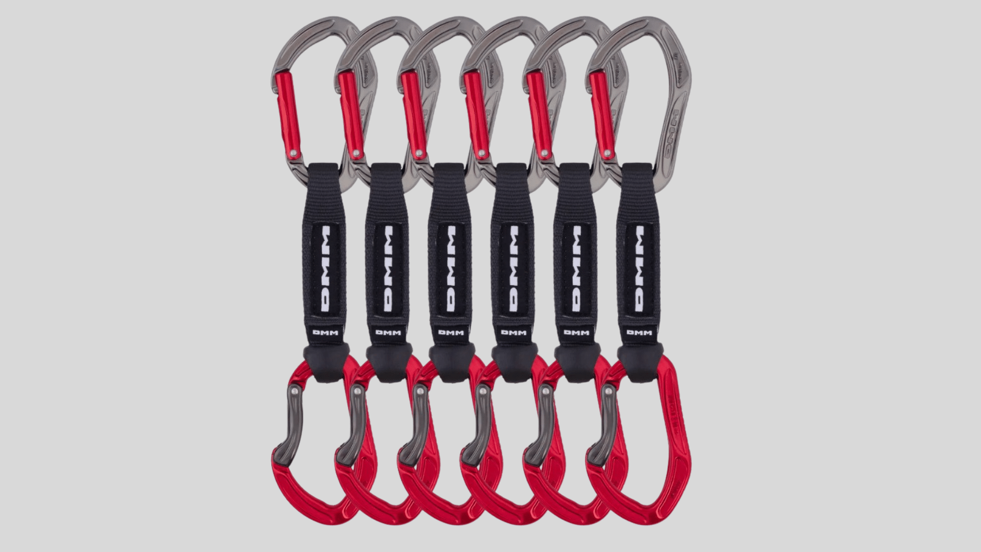 set of six climbing quickdraws with red and gray carabiners and black slings for sport climbing use on a clean background