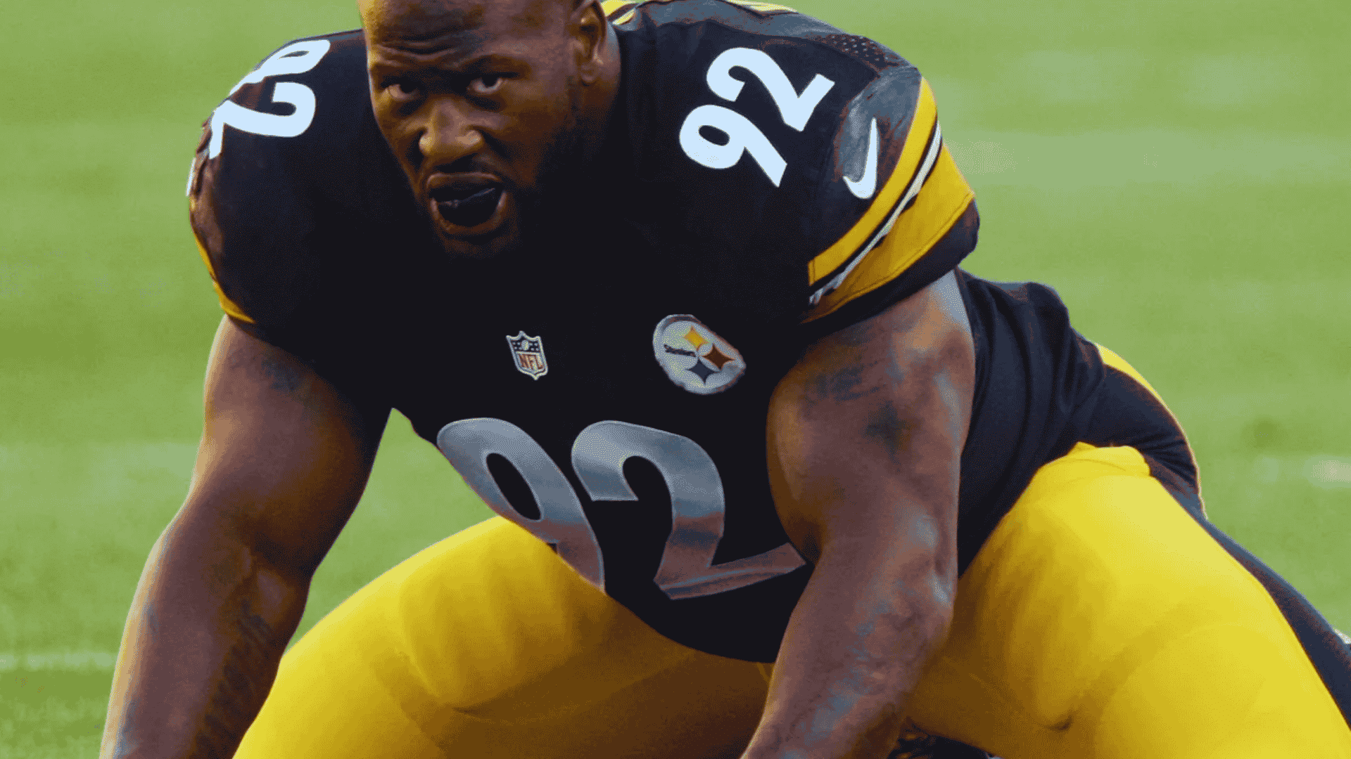 steelers defensive lineman james harrison wearing number 92 crouches low at the line of scrimmage