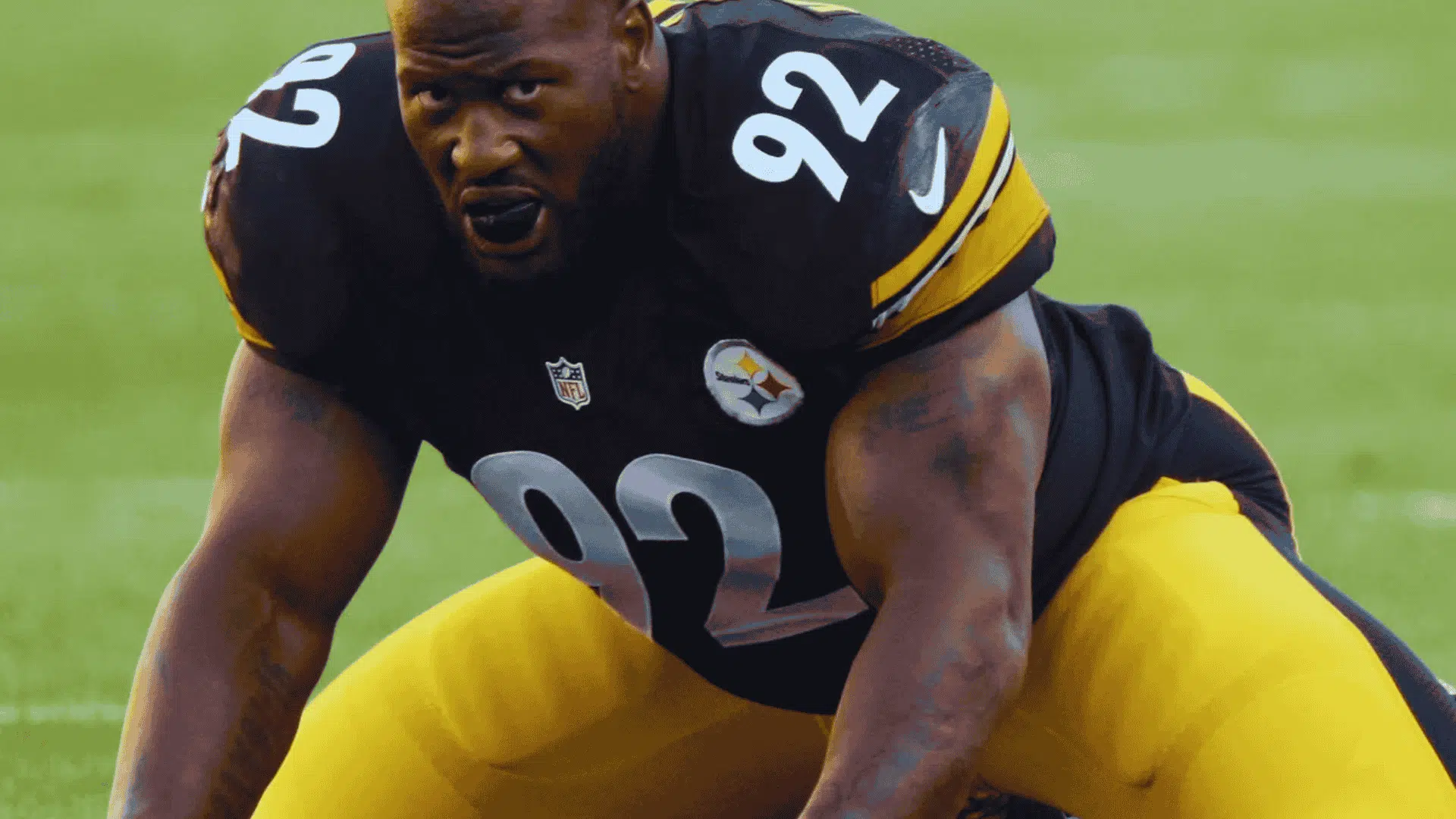 steelers defensive lineman james harrison wearing number 92 crouches low at the line of scrimmage