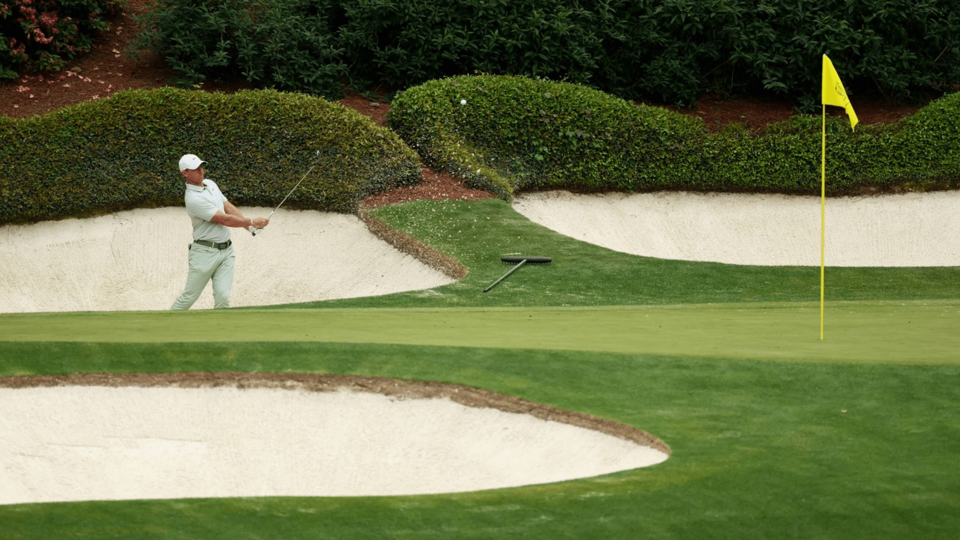 What are the 4 major golf tournaments Augusta National Golf Club hole with sand bunkers and flowering azaleas at The Masters