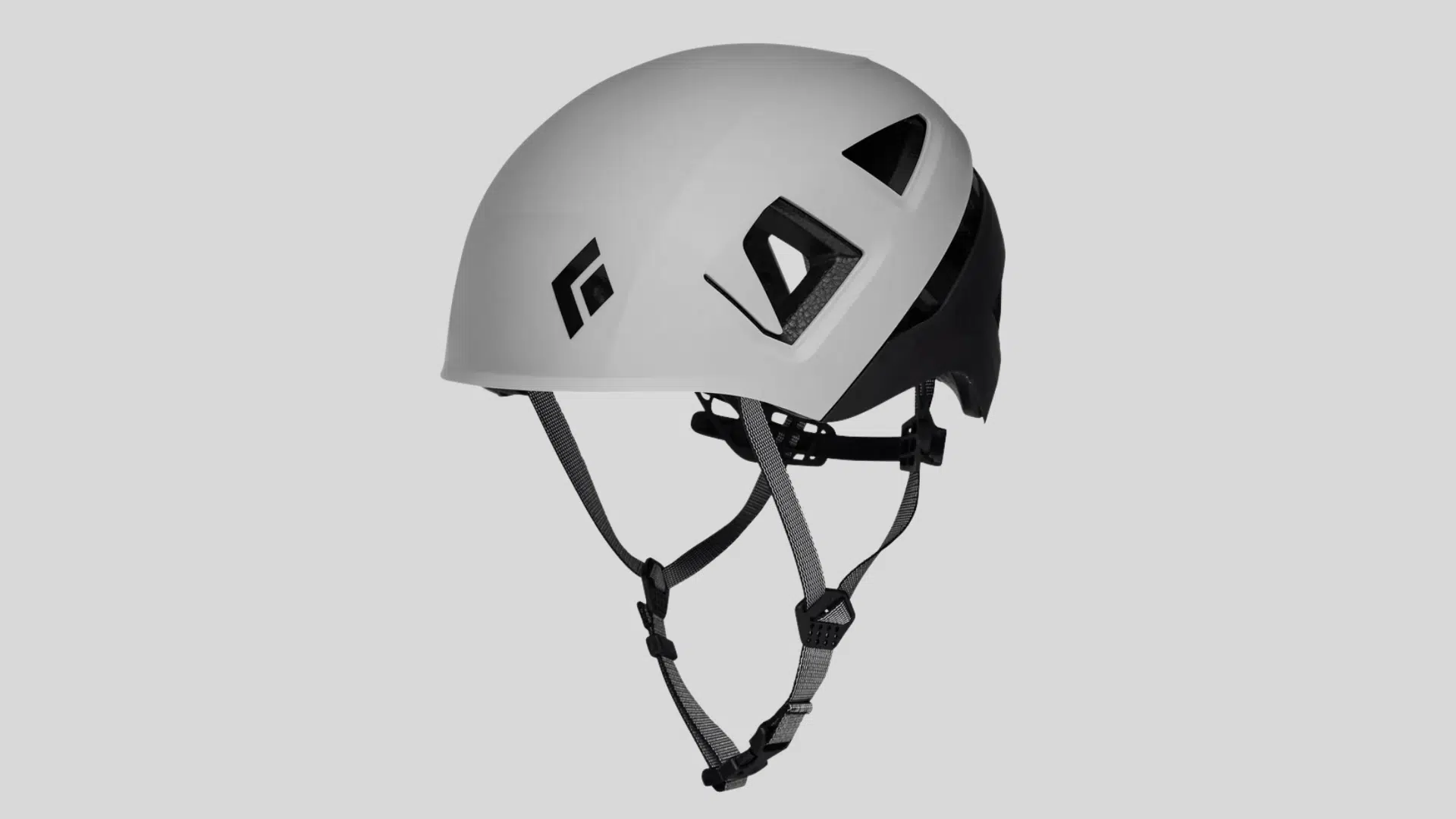 white climbing helmet with black straps and ventilation openings on a clean background