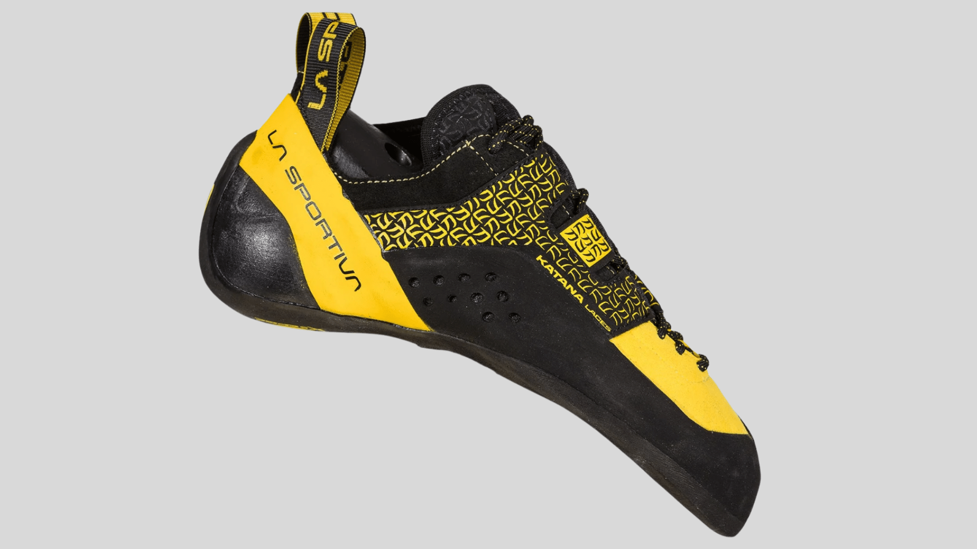 yellow and black climbing shoe with rubber sole and snug fit design for grip and precision on a clean background