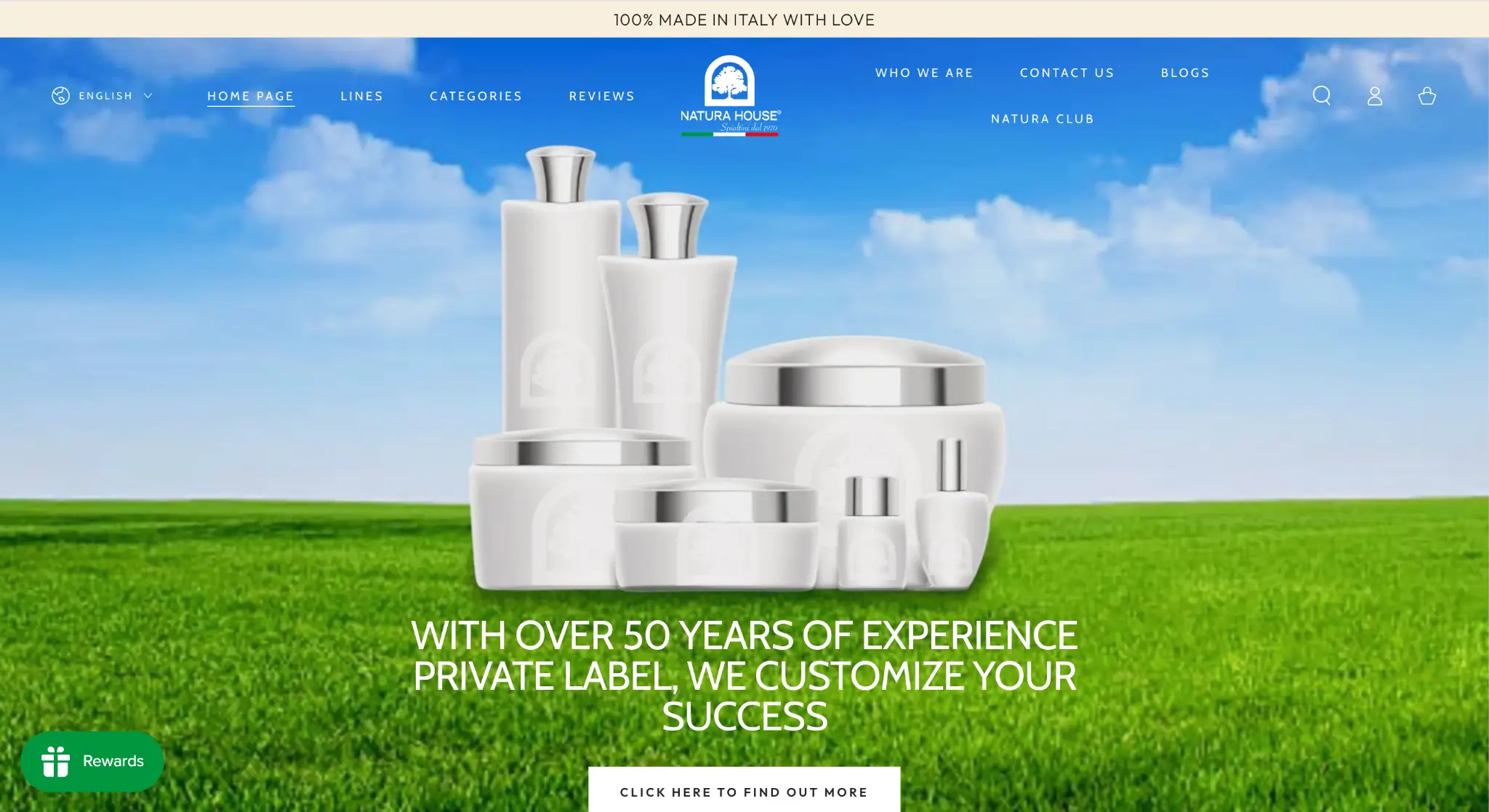 White cosmetic bottles with silver lids on grassy field under blue sky