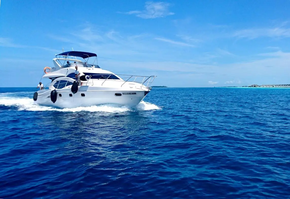 Luxury yacht cruising on clear blue ocean under bright sky