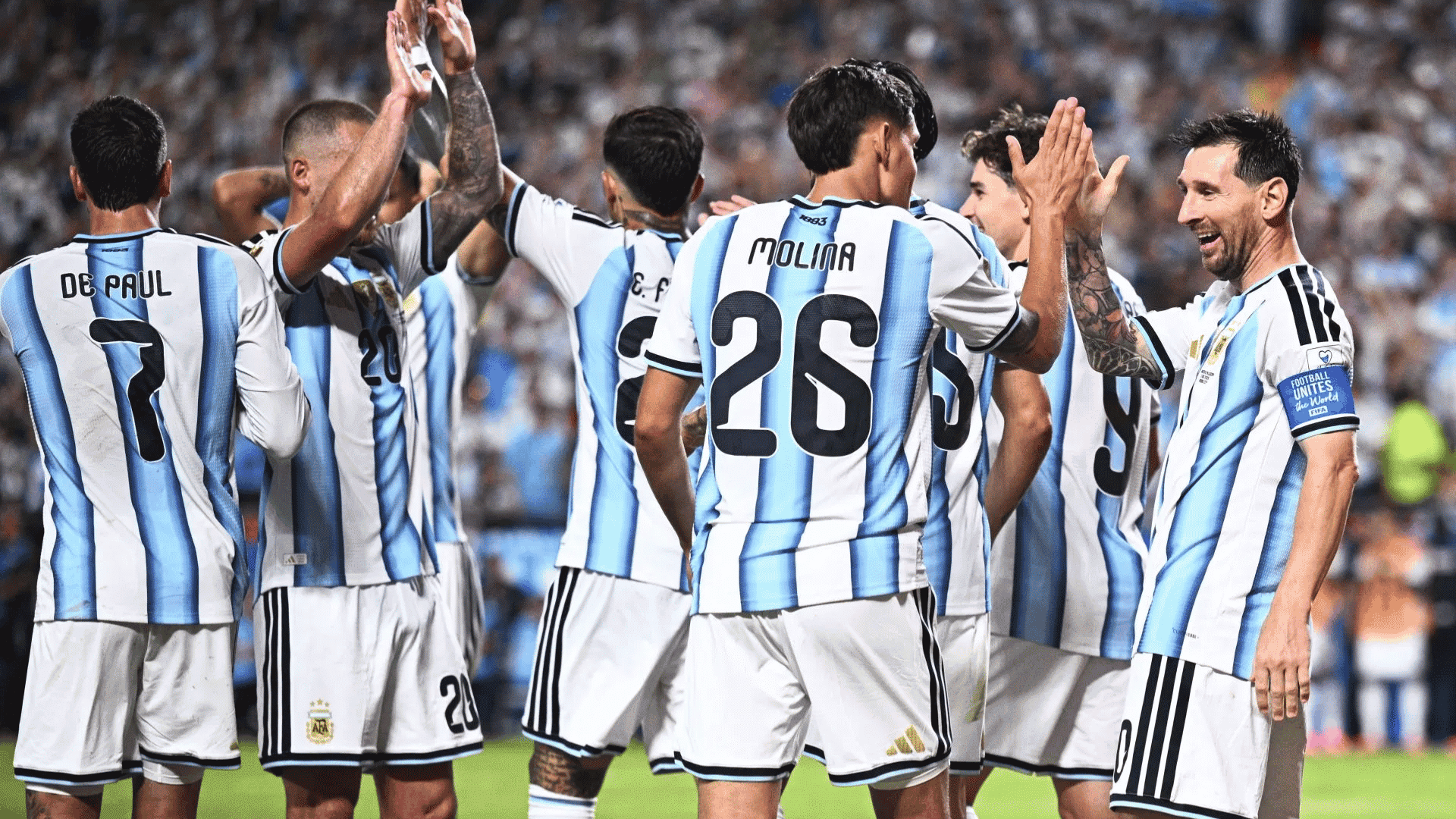 argentina national team players including molina and de paul celebrating a victory