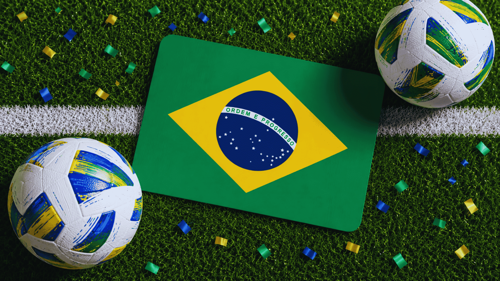 brazil flag displayed on a football pitch surrounded by modern footballs and colorful confetti