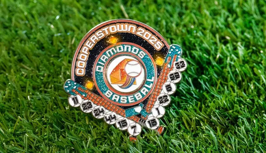Baseball-themed enamel pin with Cooperstown 2025 text on lush green grass