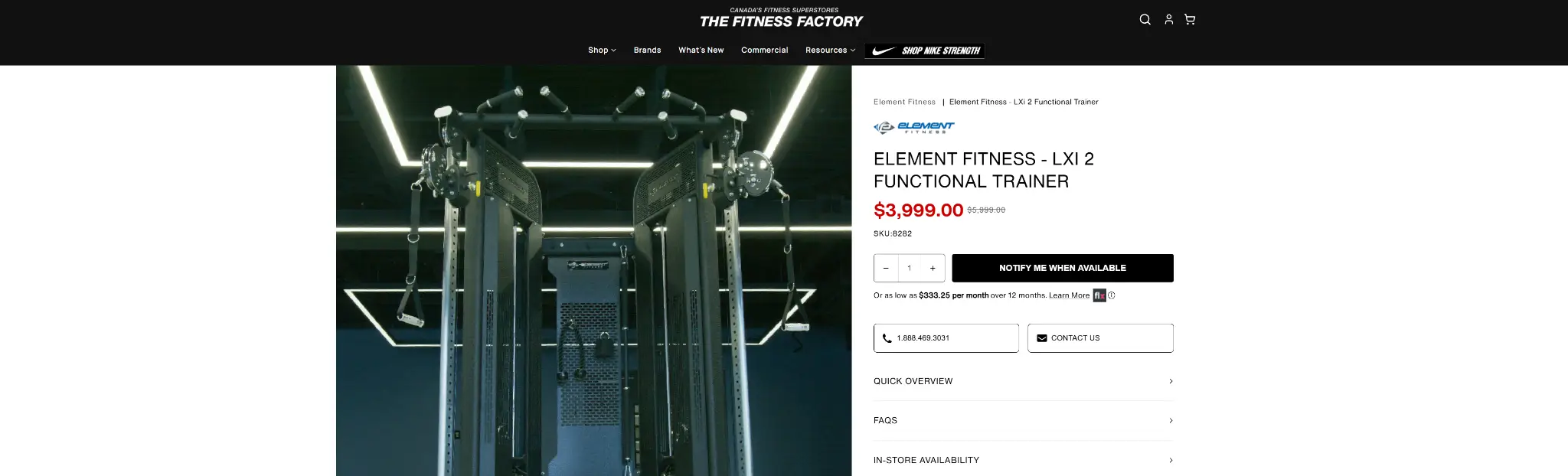 Black functional trainer equipment in dark gym setting with geometric ceiling lights