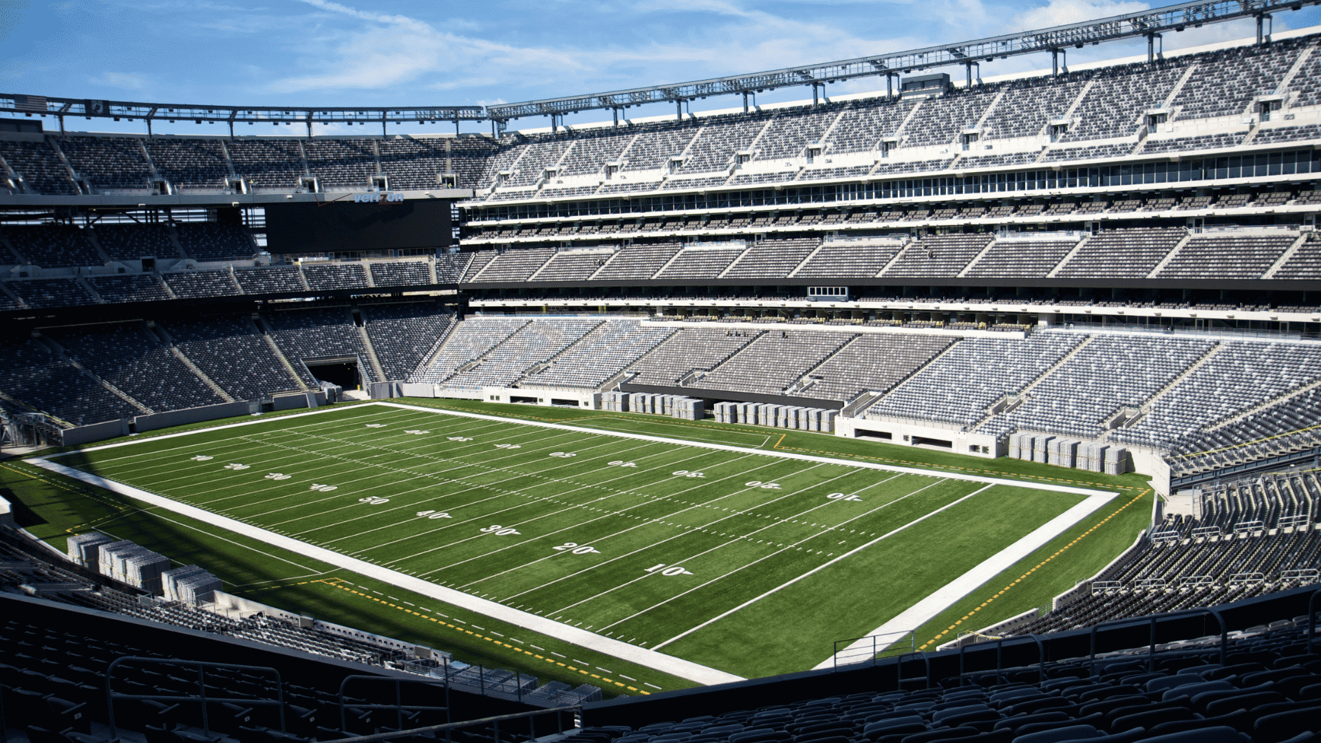 empty metlife stadium interior showing green football field and multi level seating
