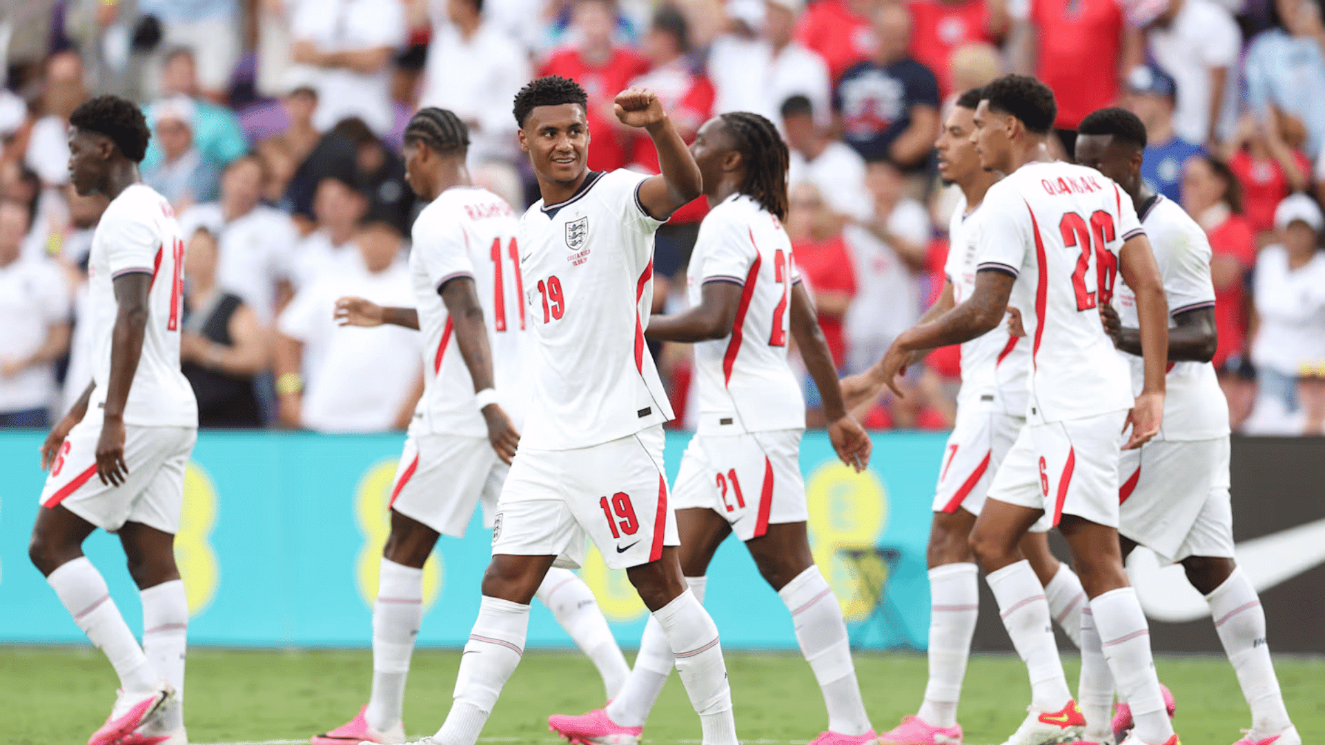 england national team players walking into the pitch with number nineteeen hands up in a fist waving to the fans
