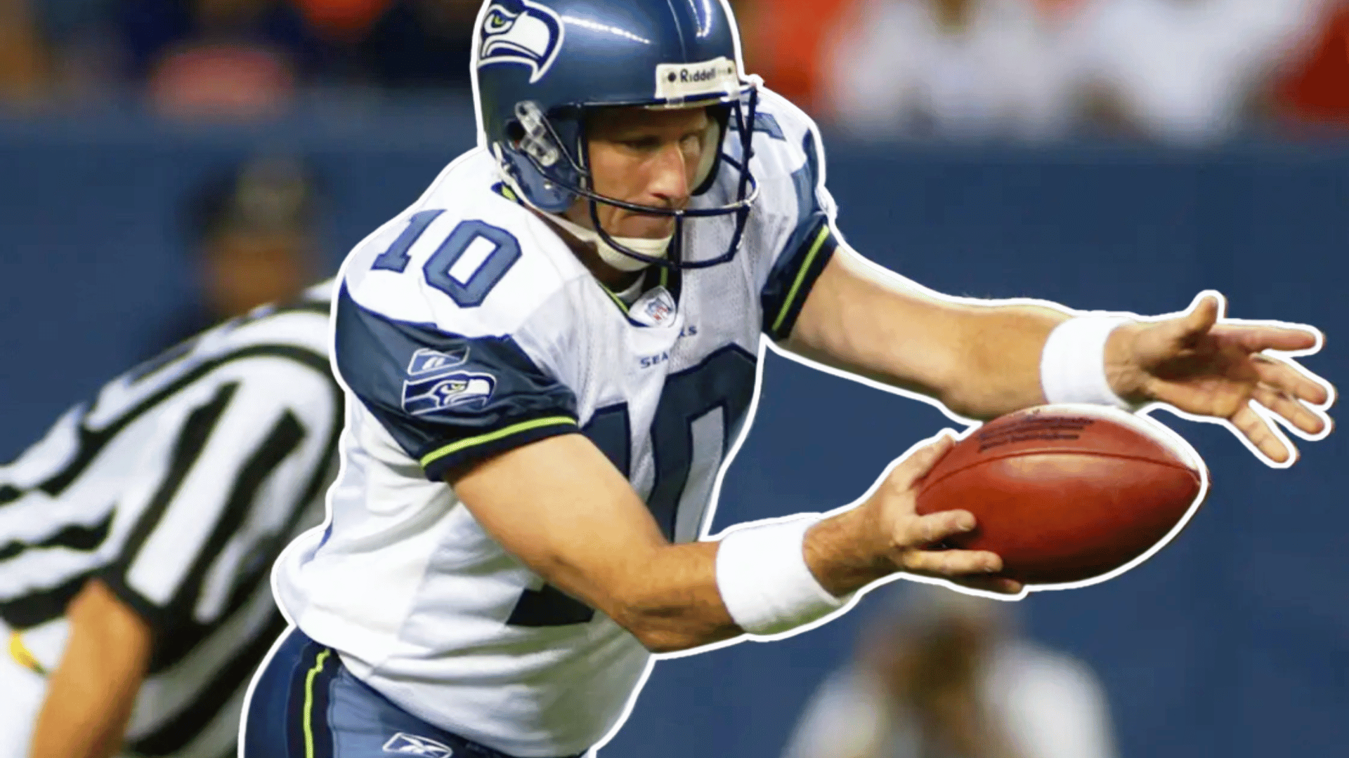 football player in a white jersey and blue helmet reaches forward to secure the football during a play on the field