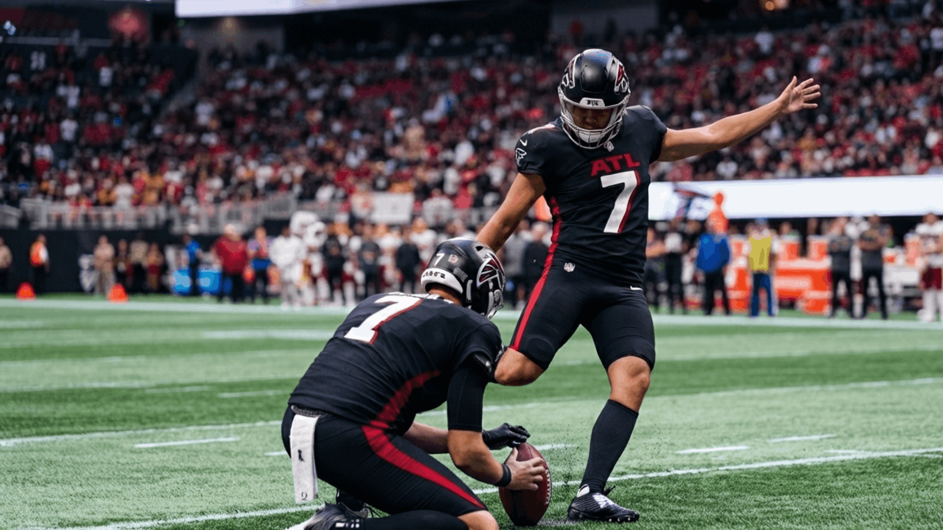 football players in black uniforms preparing for a field goal attempt during a stadium game with crowd background