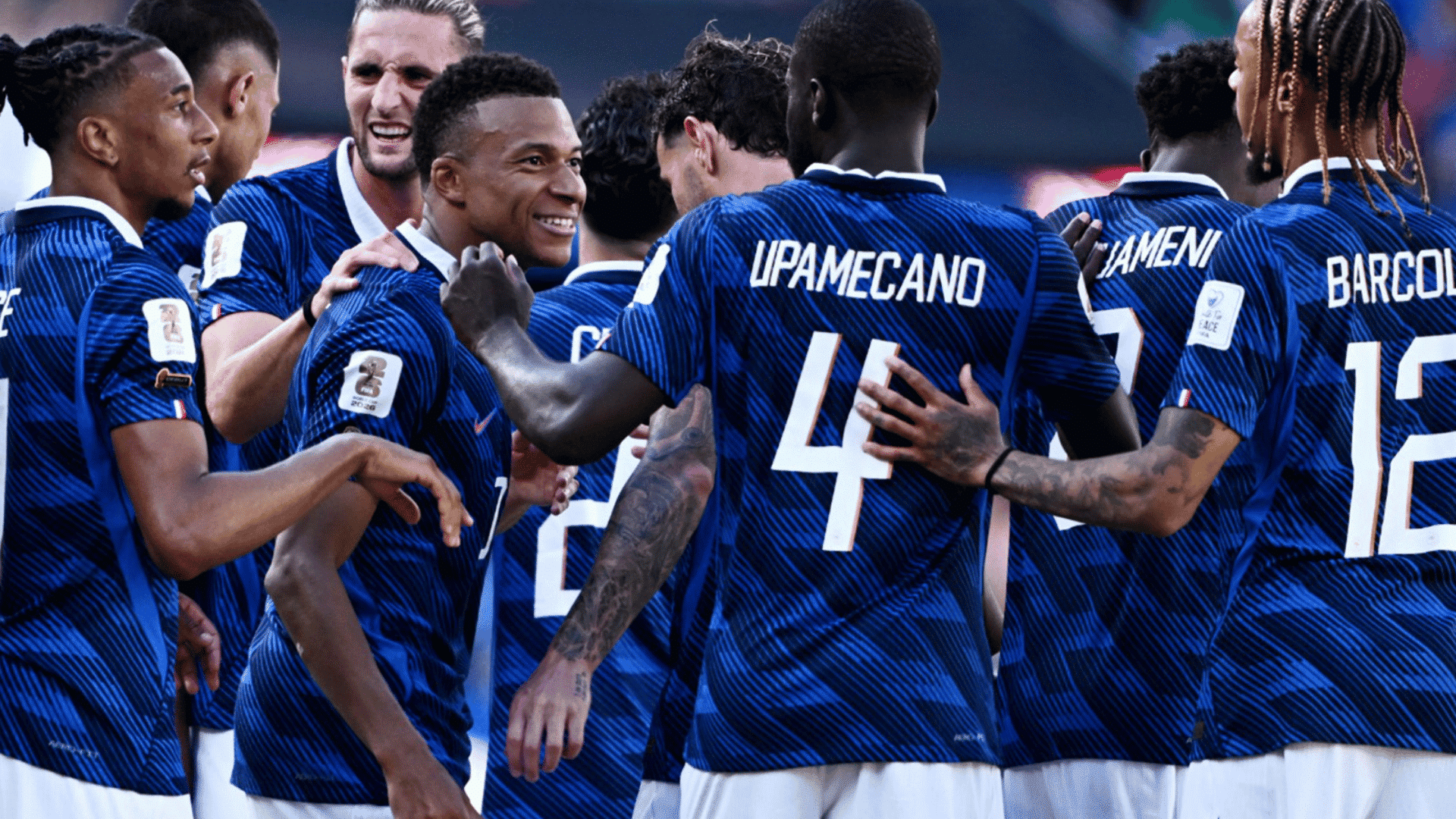 french national team players upamecano and barcola celebrating on the soccer pitch