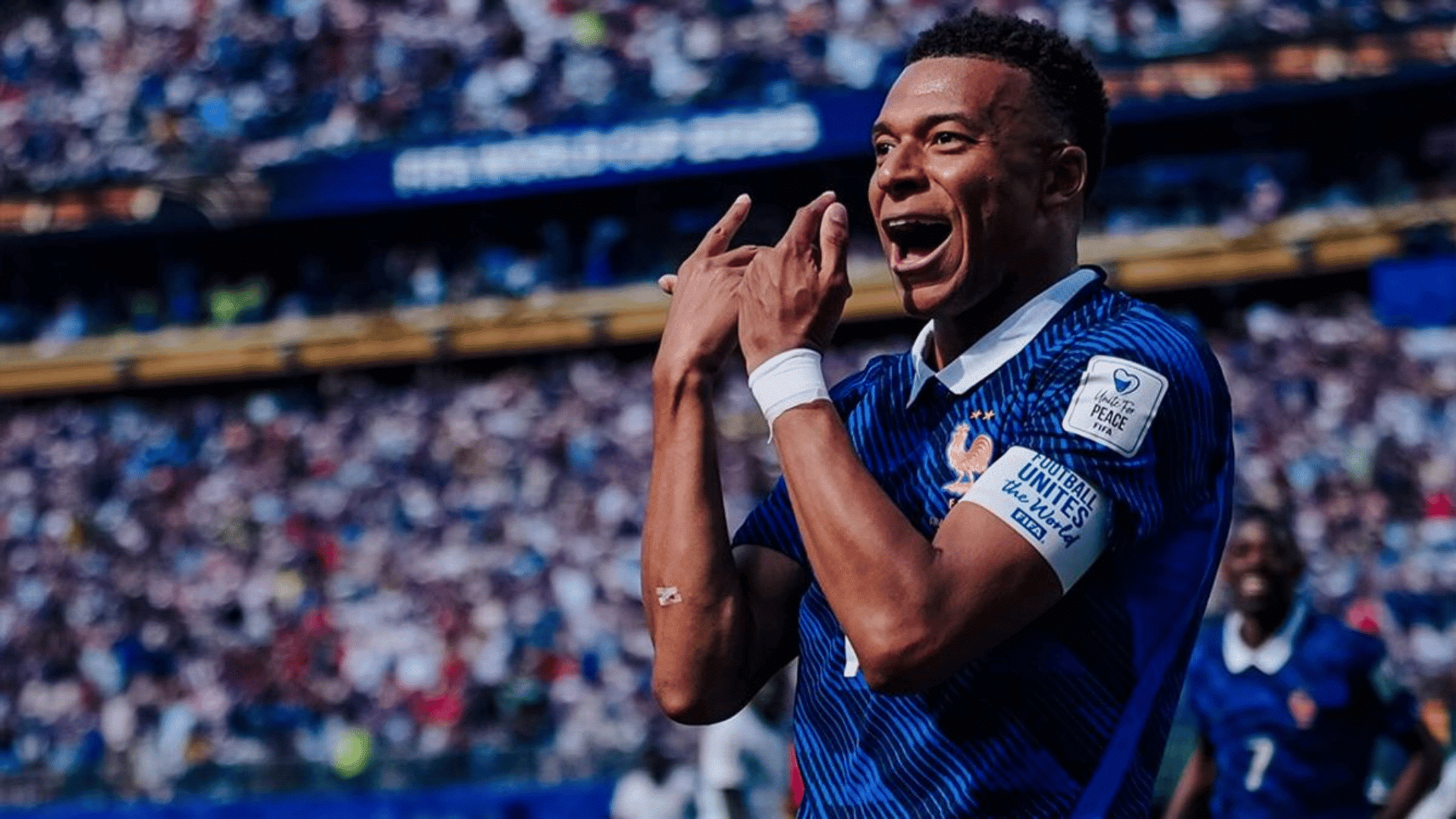 french soccer star kylian mbappe wearing a football unites the world peace armband