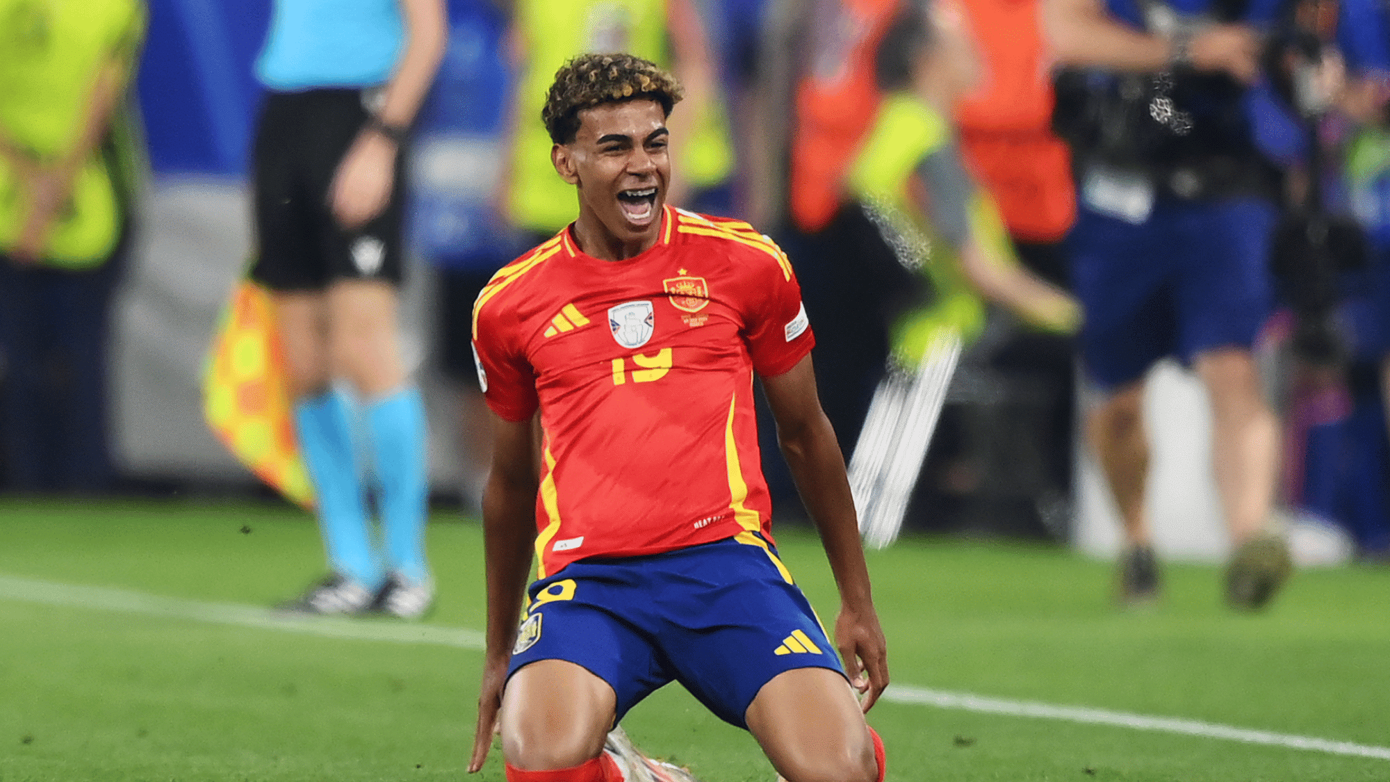 lamine yamal knee sliding in celebration after scoring a goal for spain during an international football match