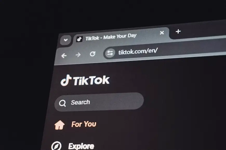 TikTok website homepage displayed on a dark mode browser screen