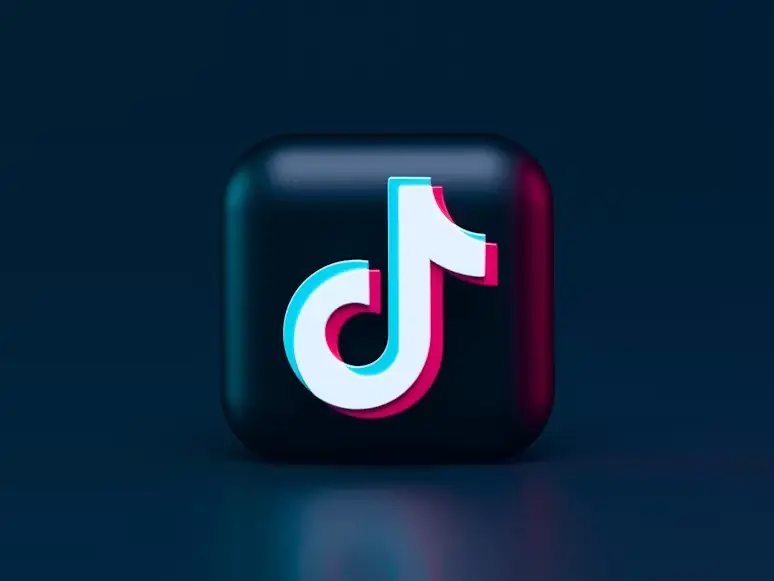 3D TikTok logo icon on dark blue background with neon lighting effects