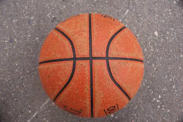 Basketball resting on textured concrete surface viewed from above
