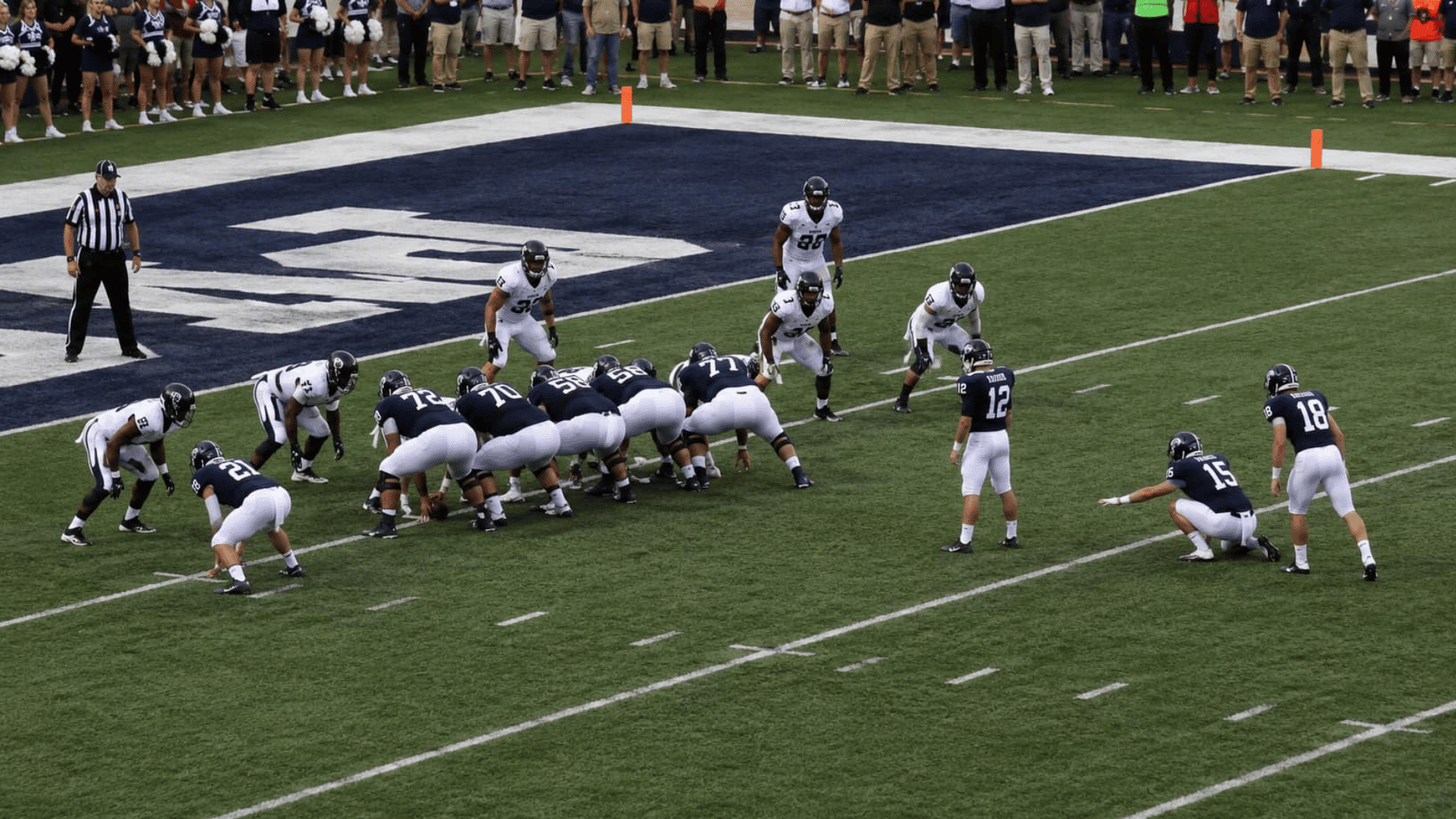 football team using the swinging gate formation near the goal line as the defense adjusts before a two point attempt