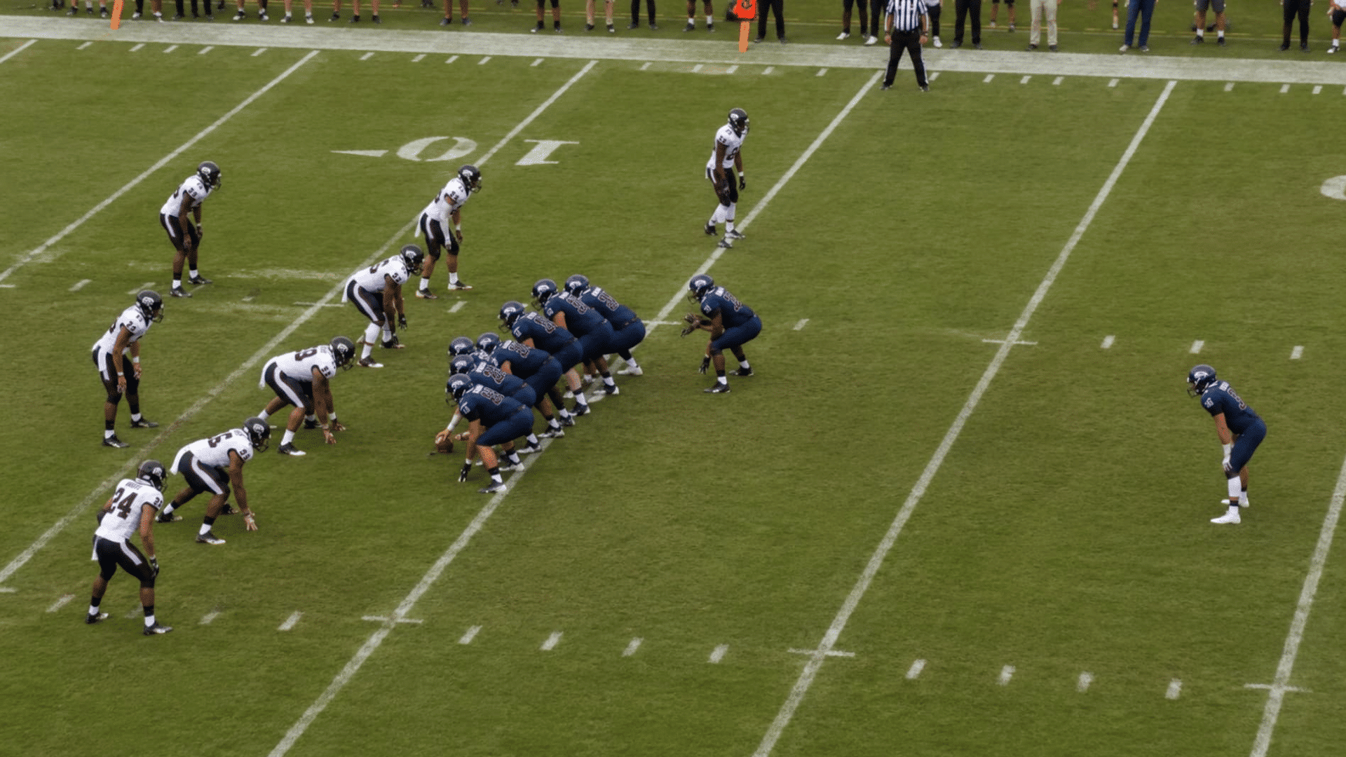 realistic swinging gate football formation showing an unbalanced offensive line before the snap as defenders adjust quickly