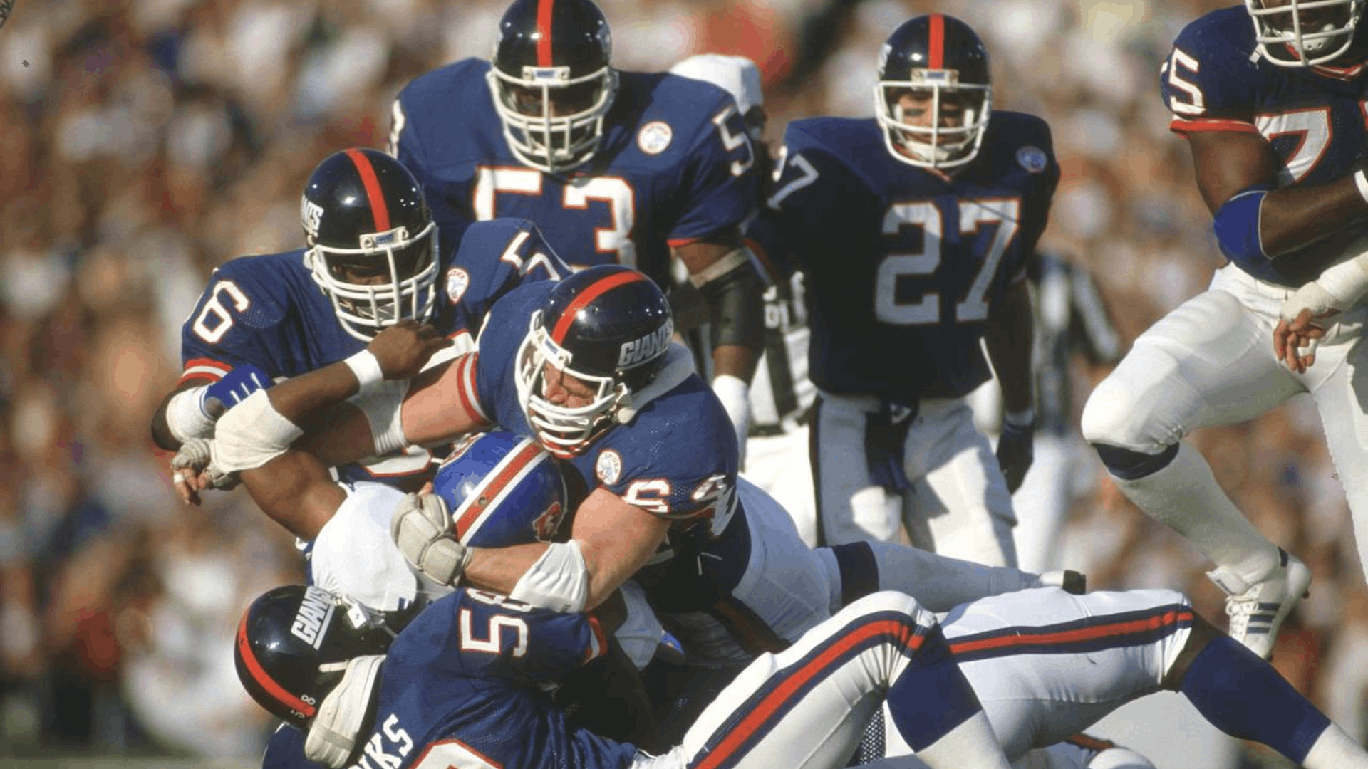 1986 new york giants defenders tackling an opposing ball carrier during a physical nfl game